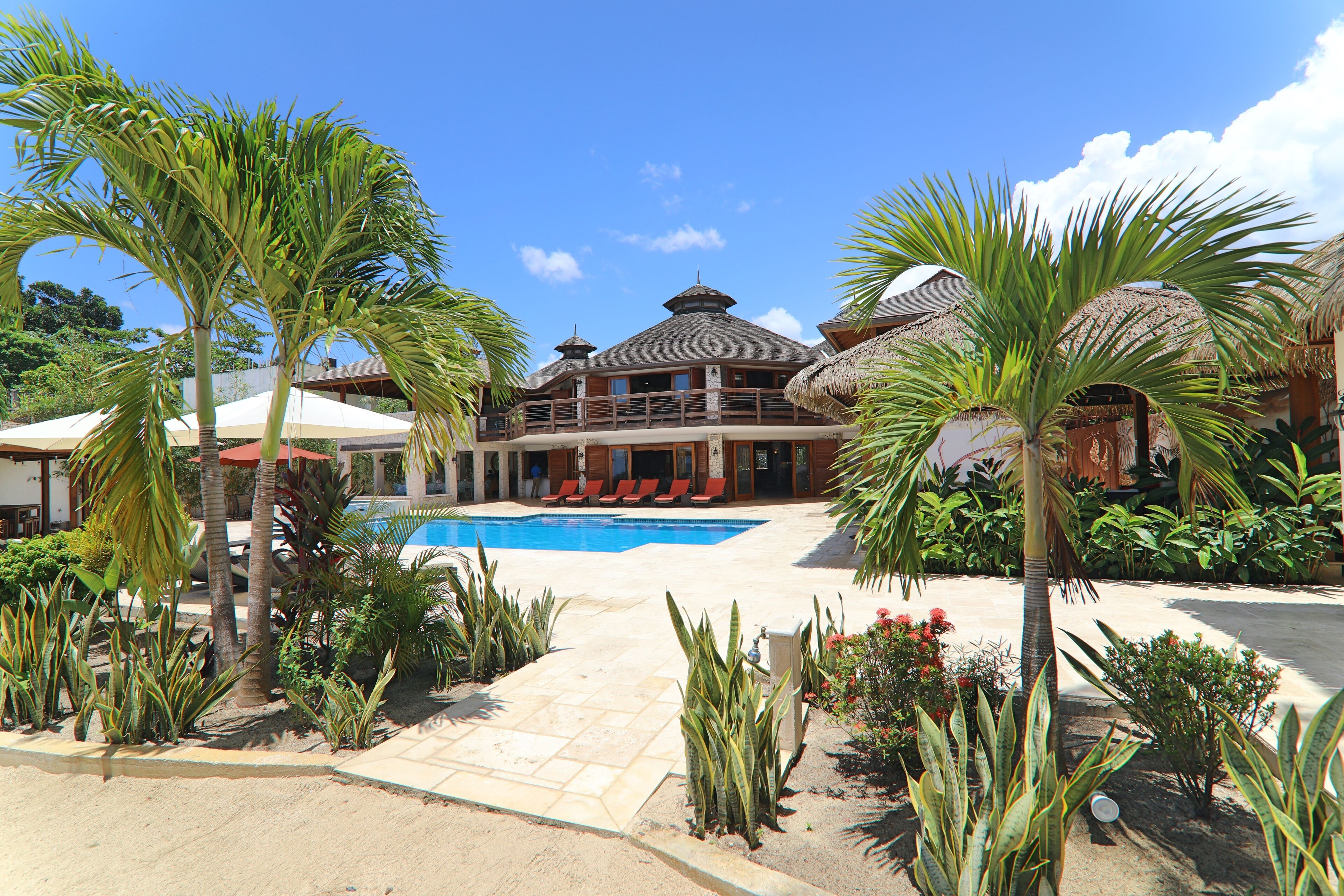 The pool, the garden, and the villa.