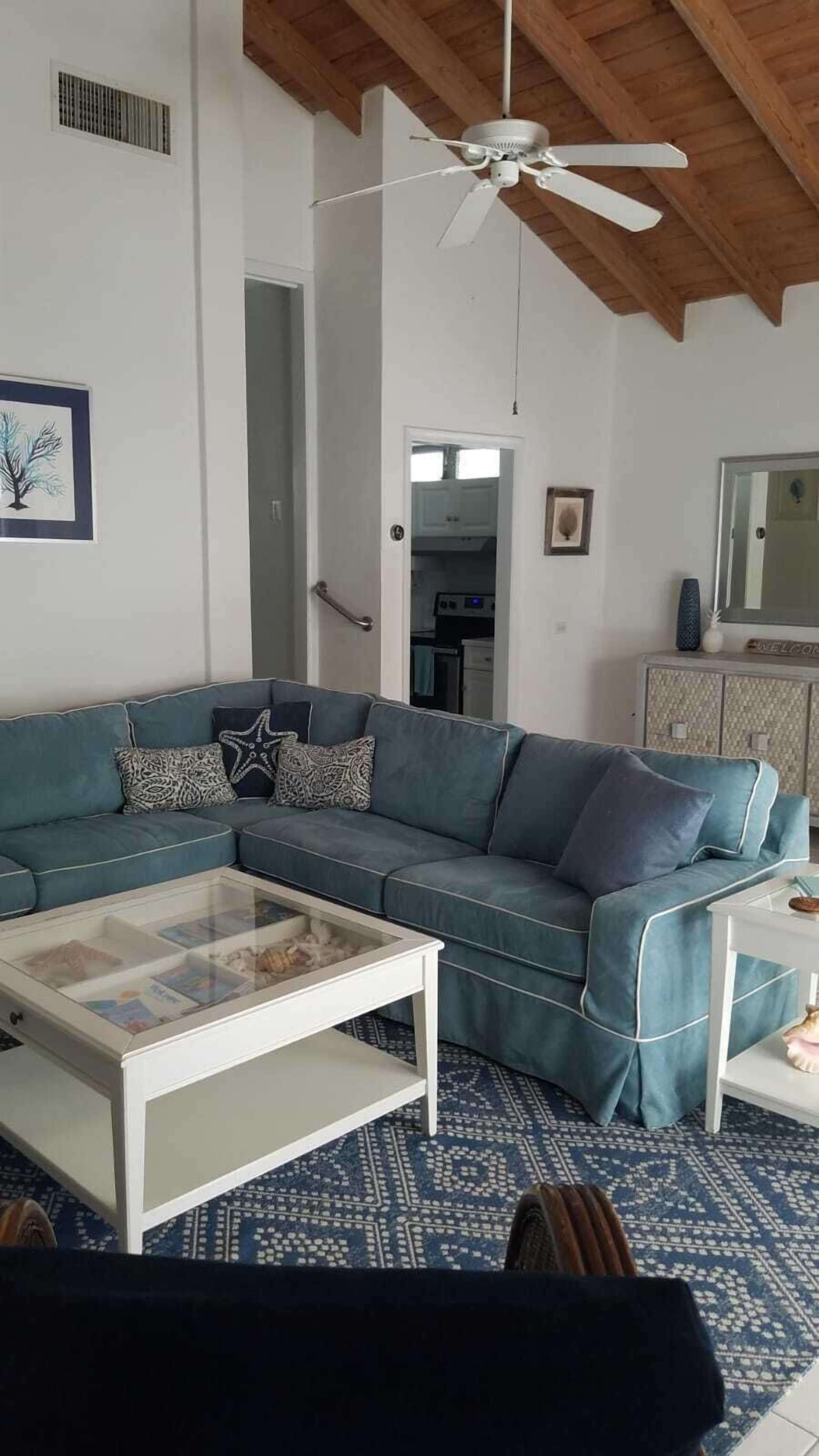 The blue corner sofa and a white coffee table in the living room.