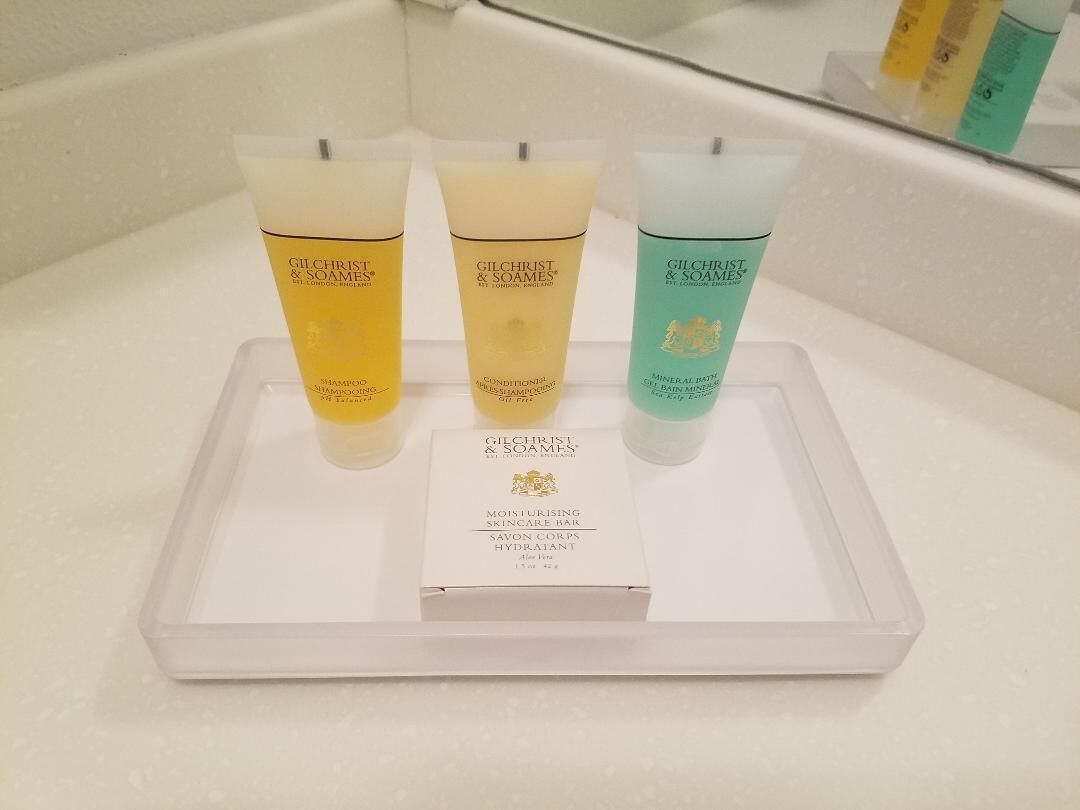 A tray with soap, shampoo, and conditioner in the bathroom.