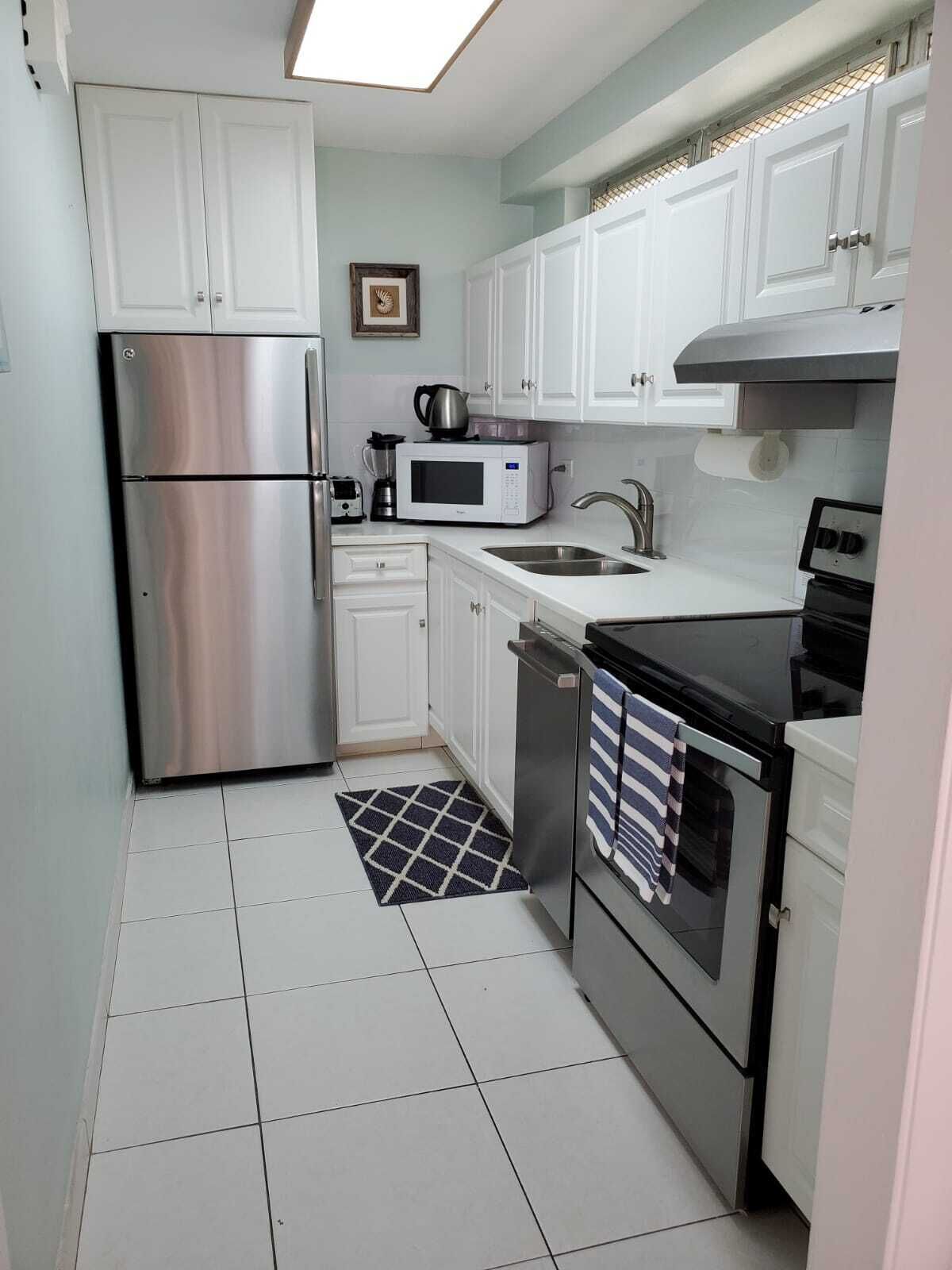 The kitchen with a refrigerator, a stove, and a microwave.