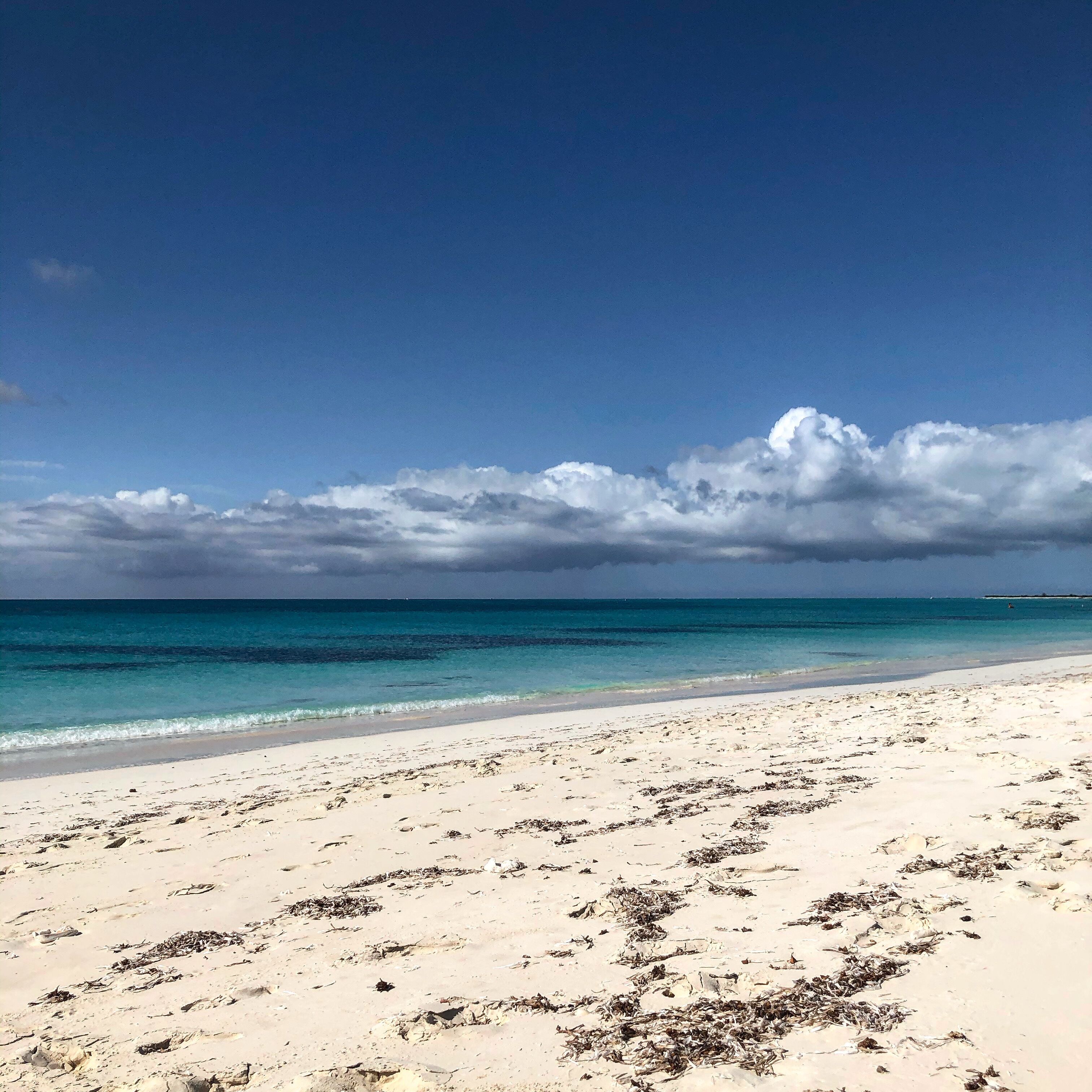 The beach has white sand and clear turquoise water.