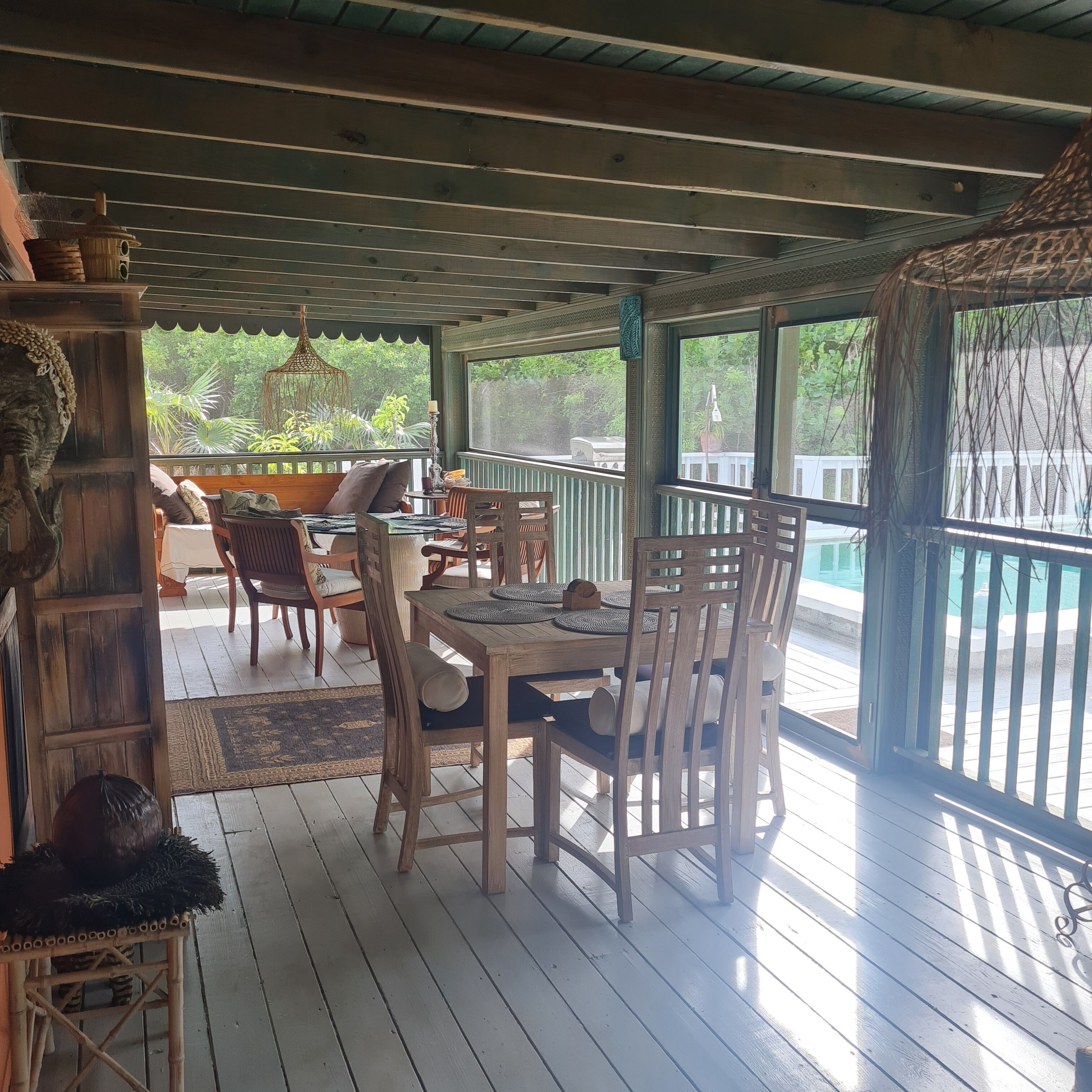Tables and chairs on the screened porch.