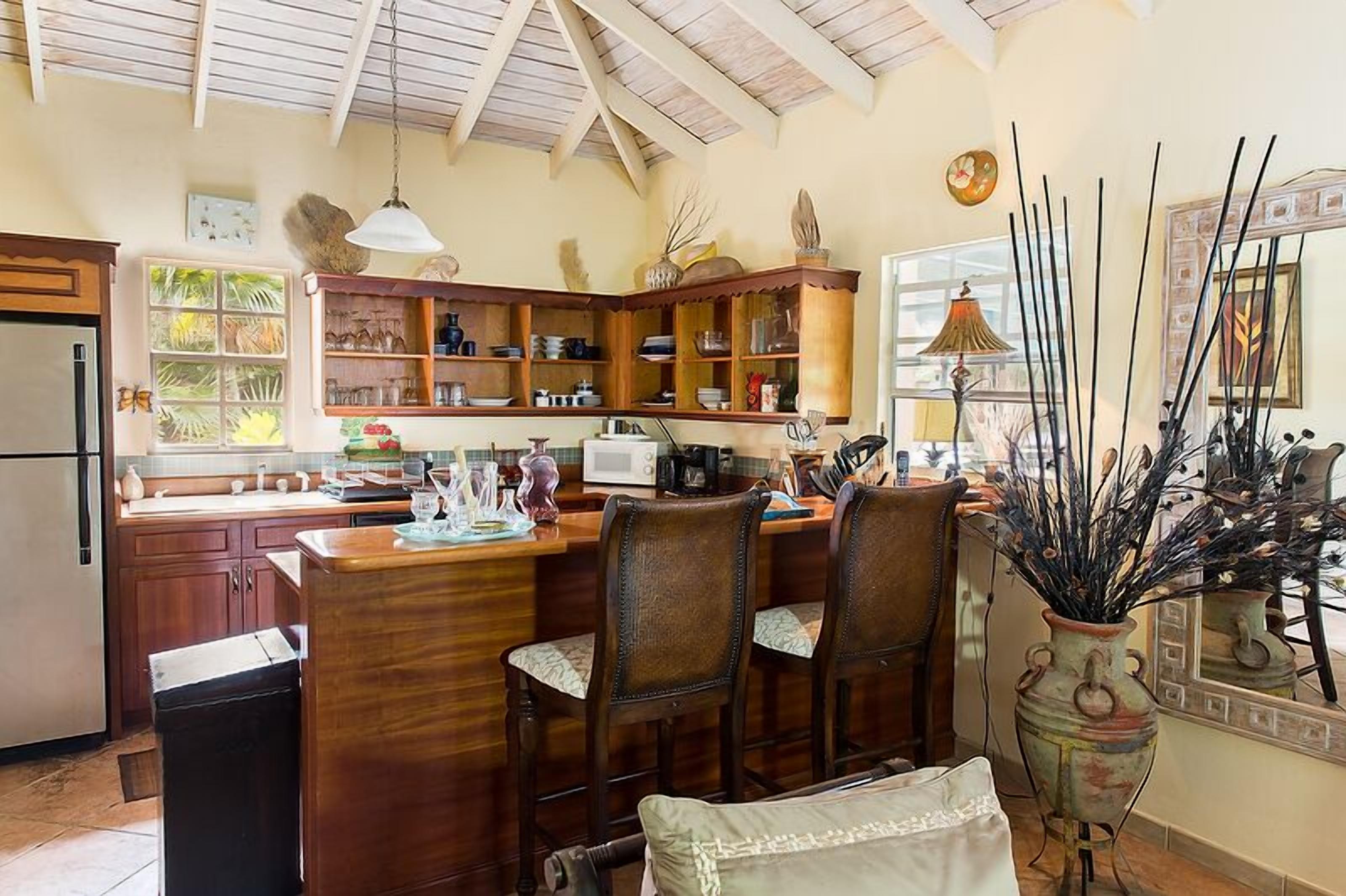 The kitchen with a wood breakfast bar.