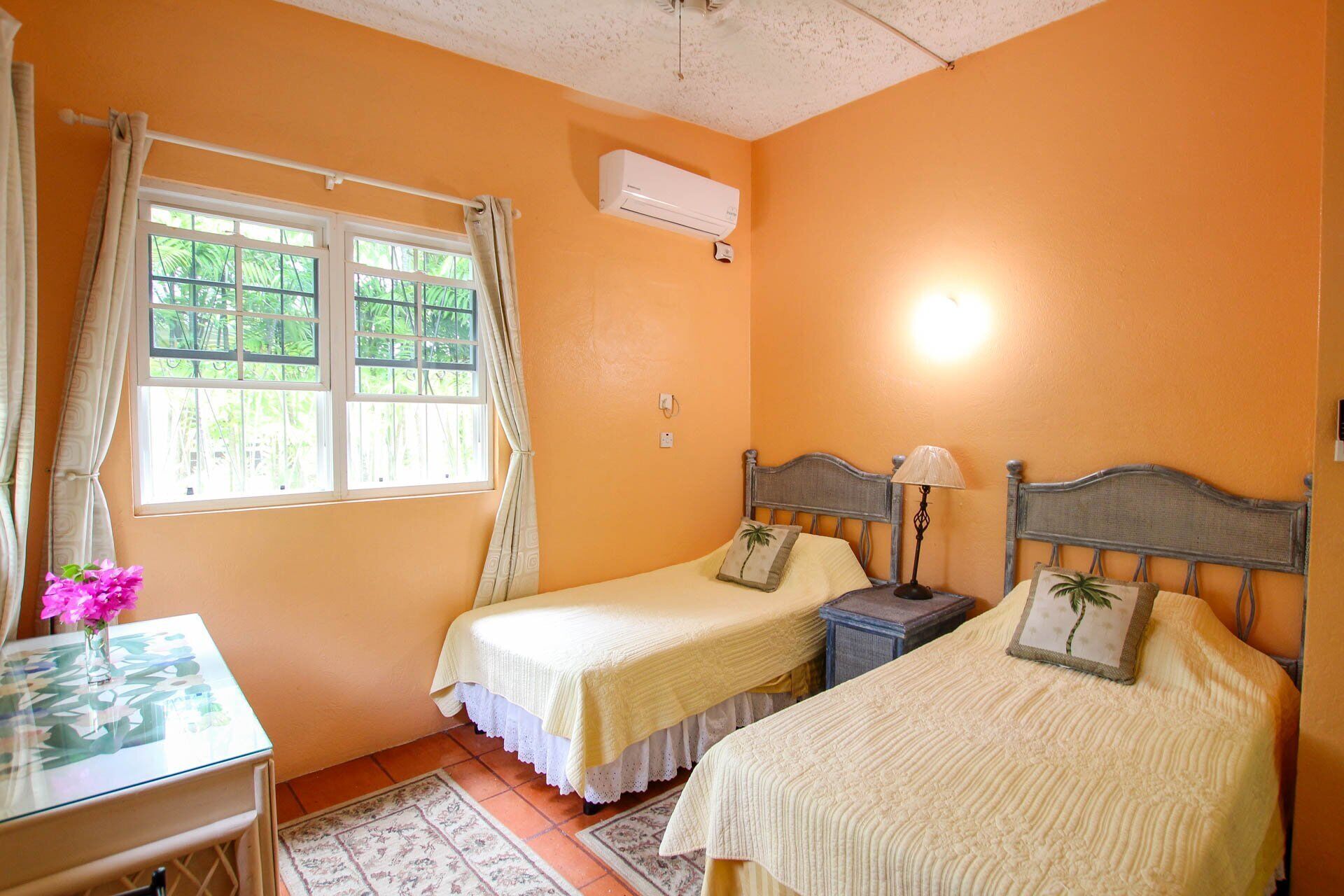 A bedroom with two single beds.