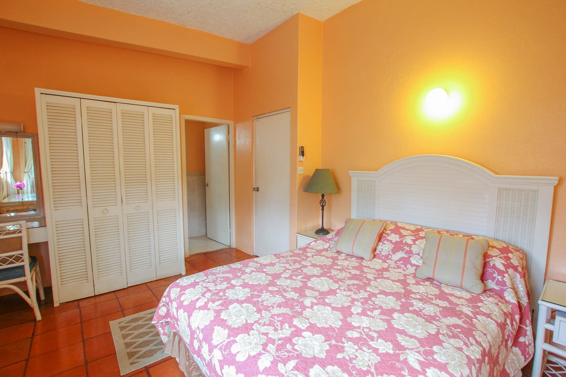 A bedroom with a double bed and a closet.