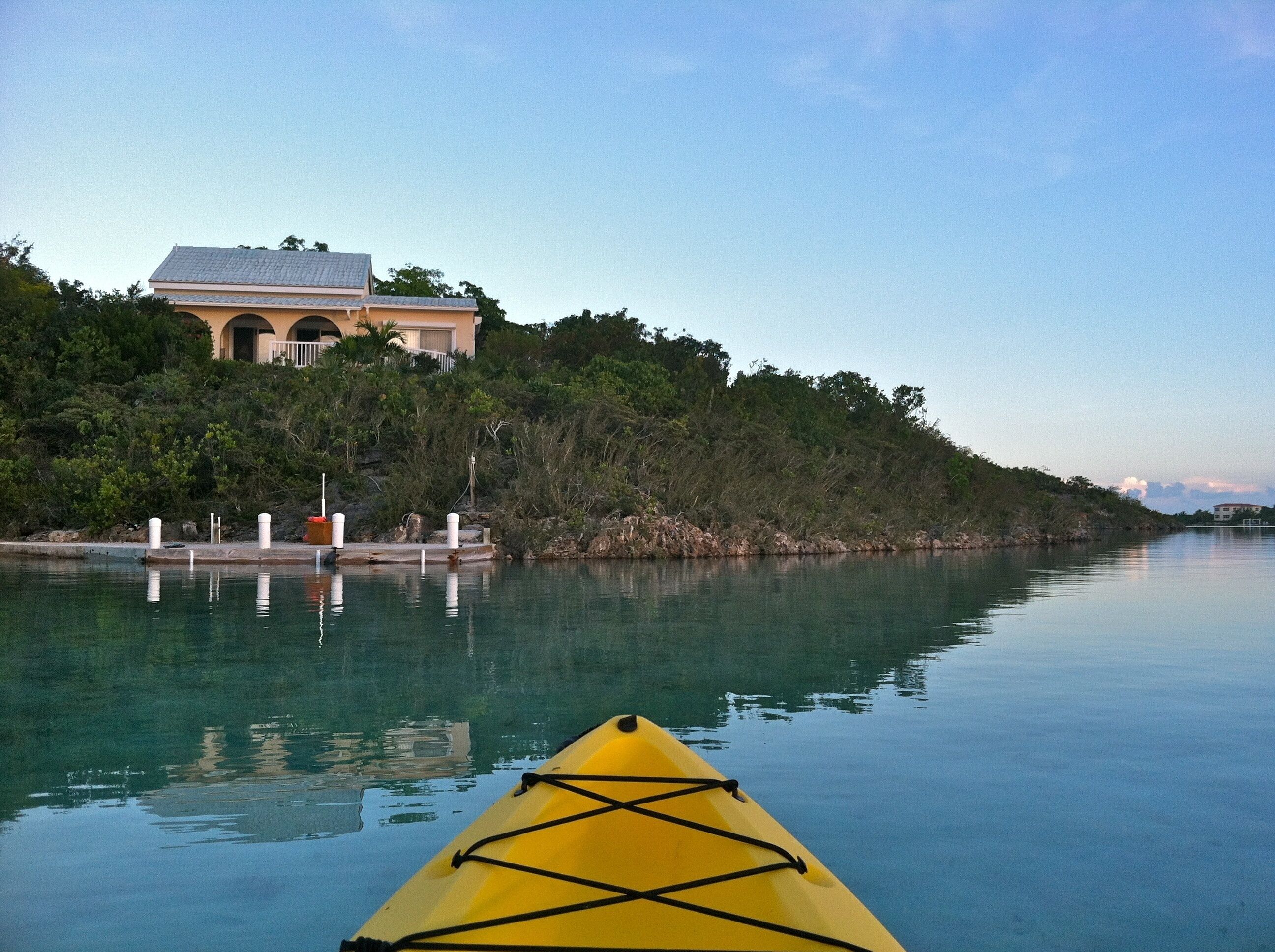 A view from a kayak toward the villa and the dock.