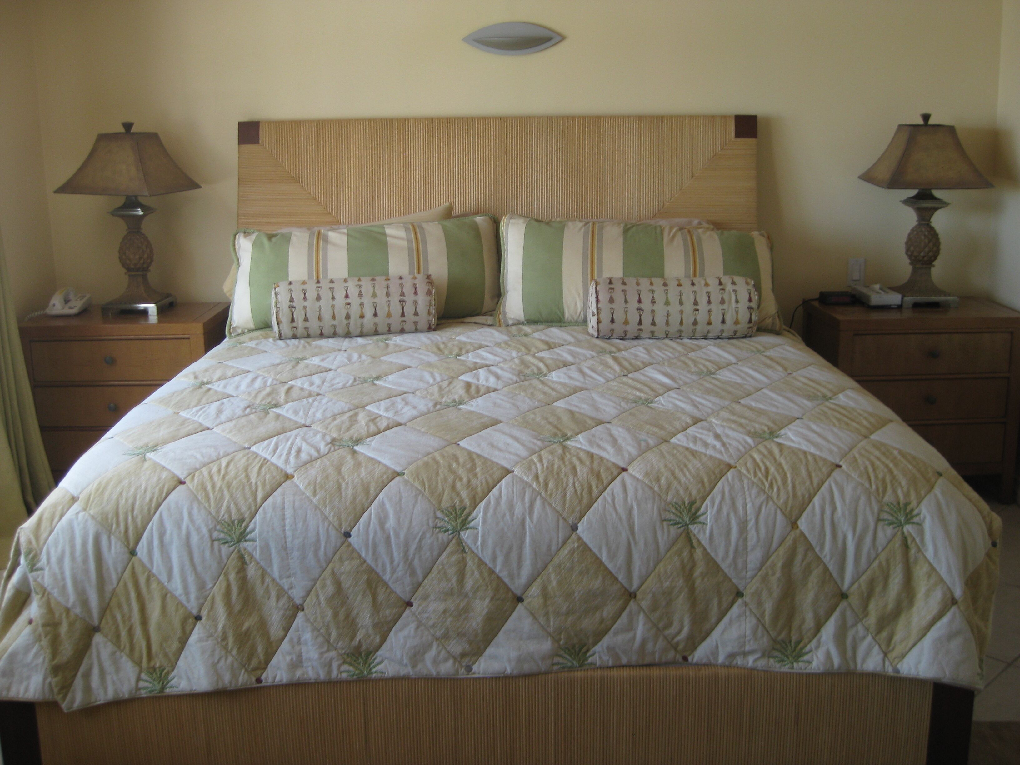 A bedroom with a large bed, two nightstands, and two lamps.