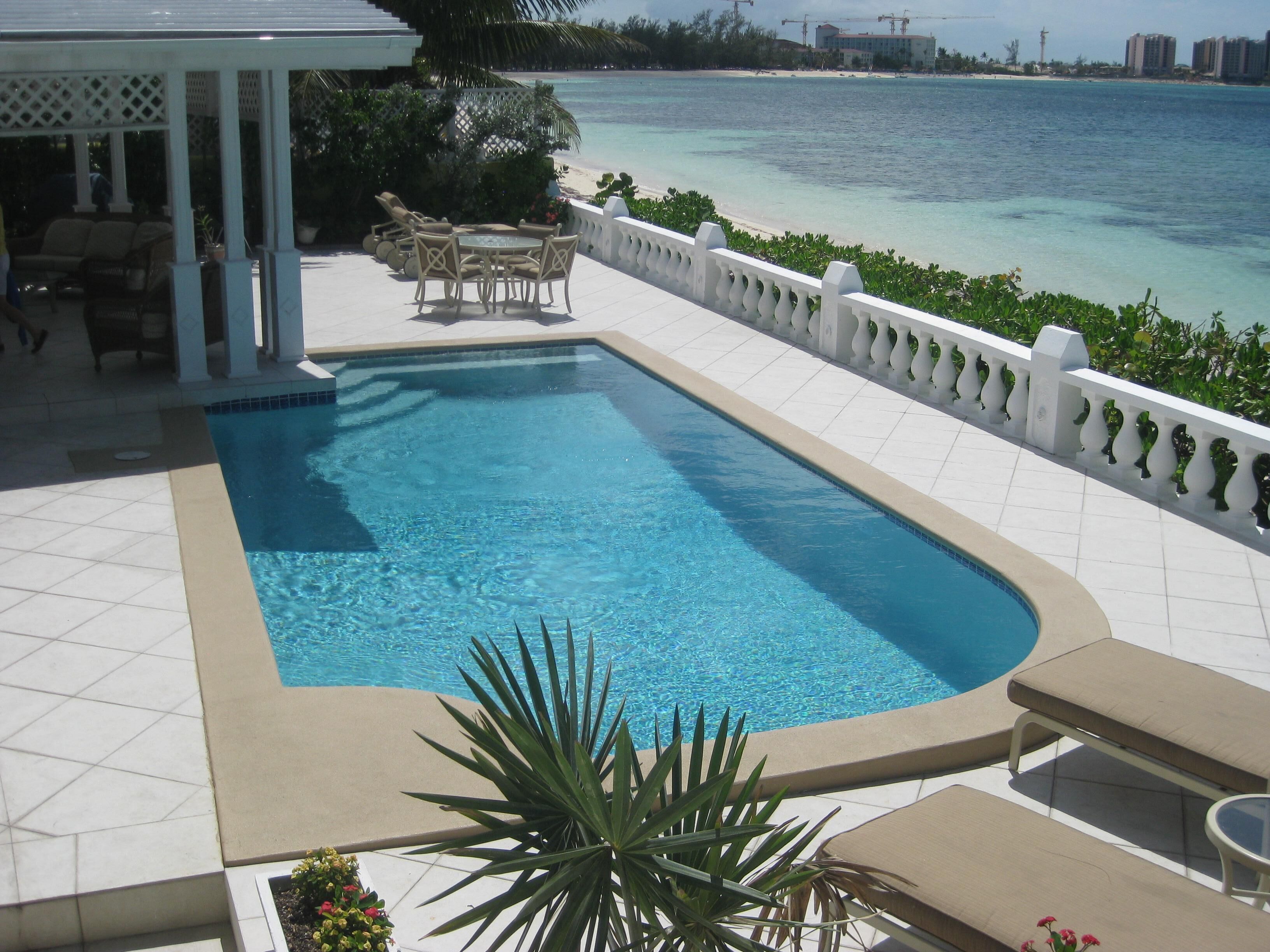 A view of the pool, the white balustrade, and Cable Beach.