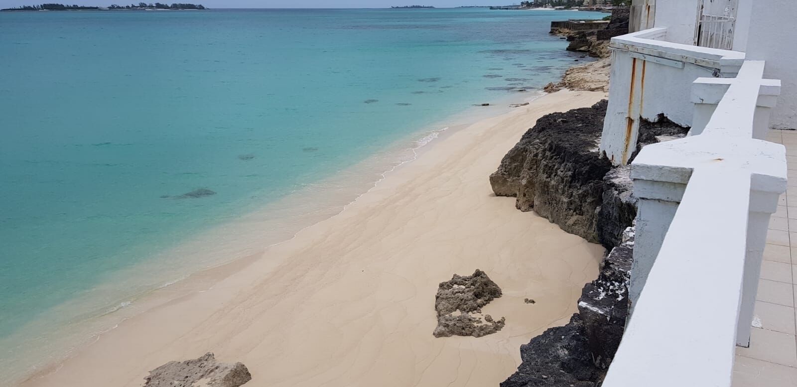 The beach with rocks below the terrace of the villa.