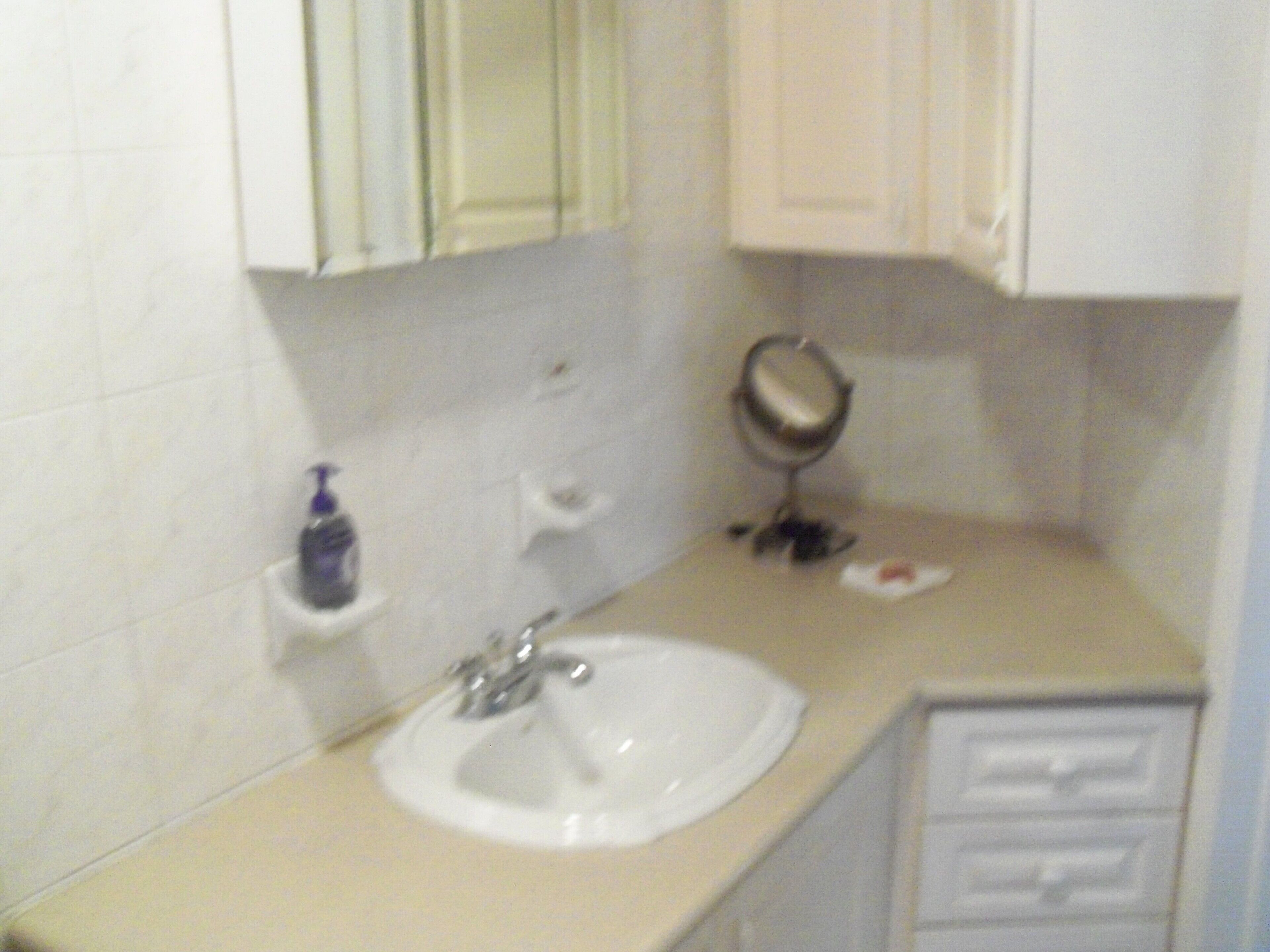 The bathroom has a sink, a mirror cabinet, and a vanity.