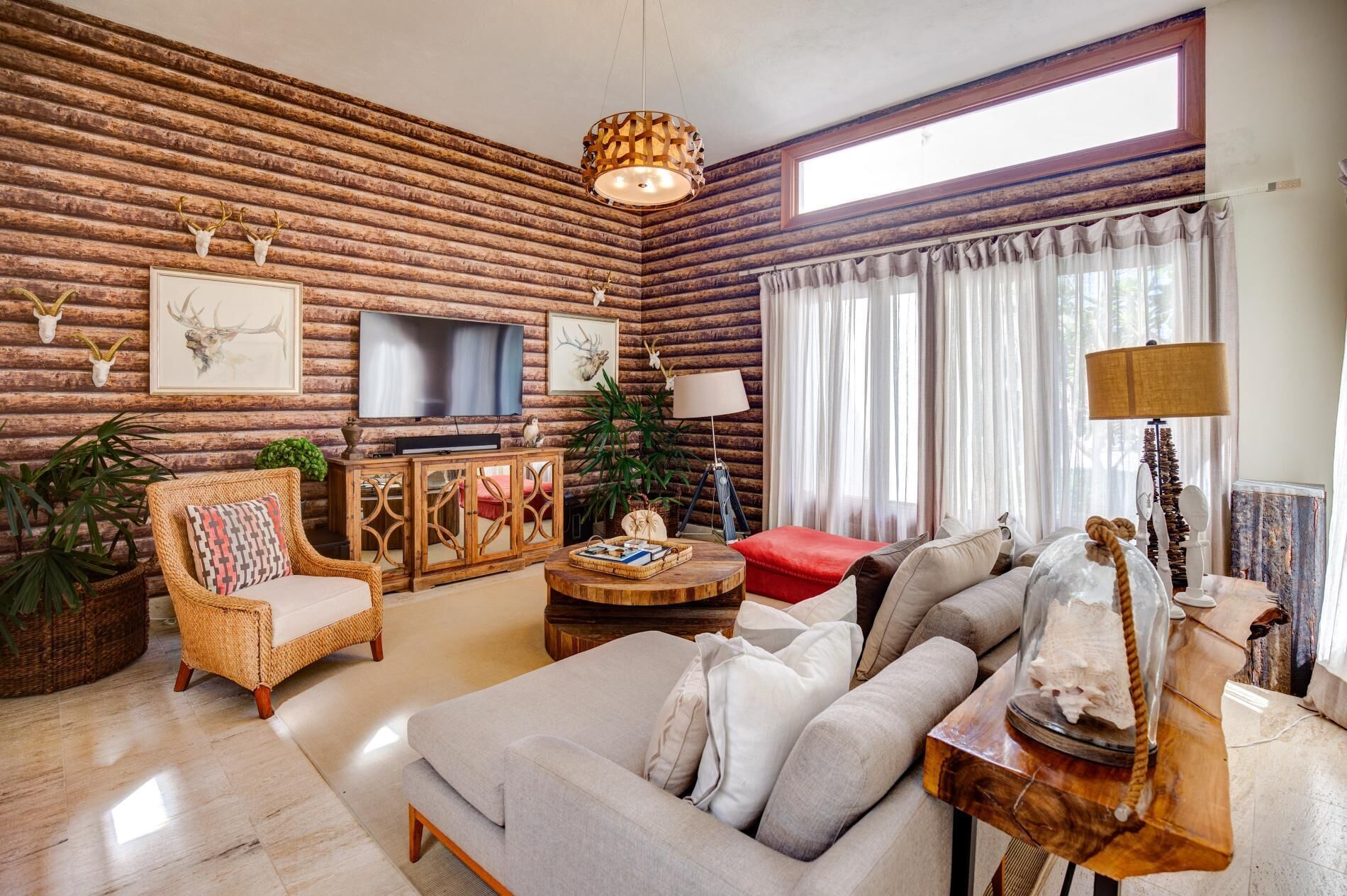 A living room with two sofas, a television, and a round wood table.