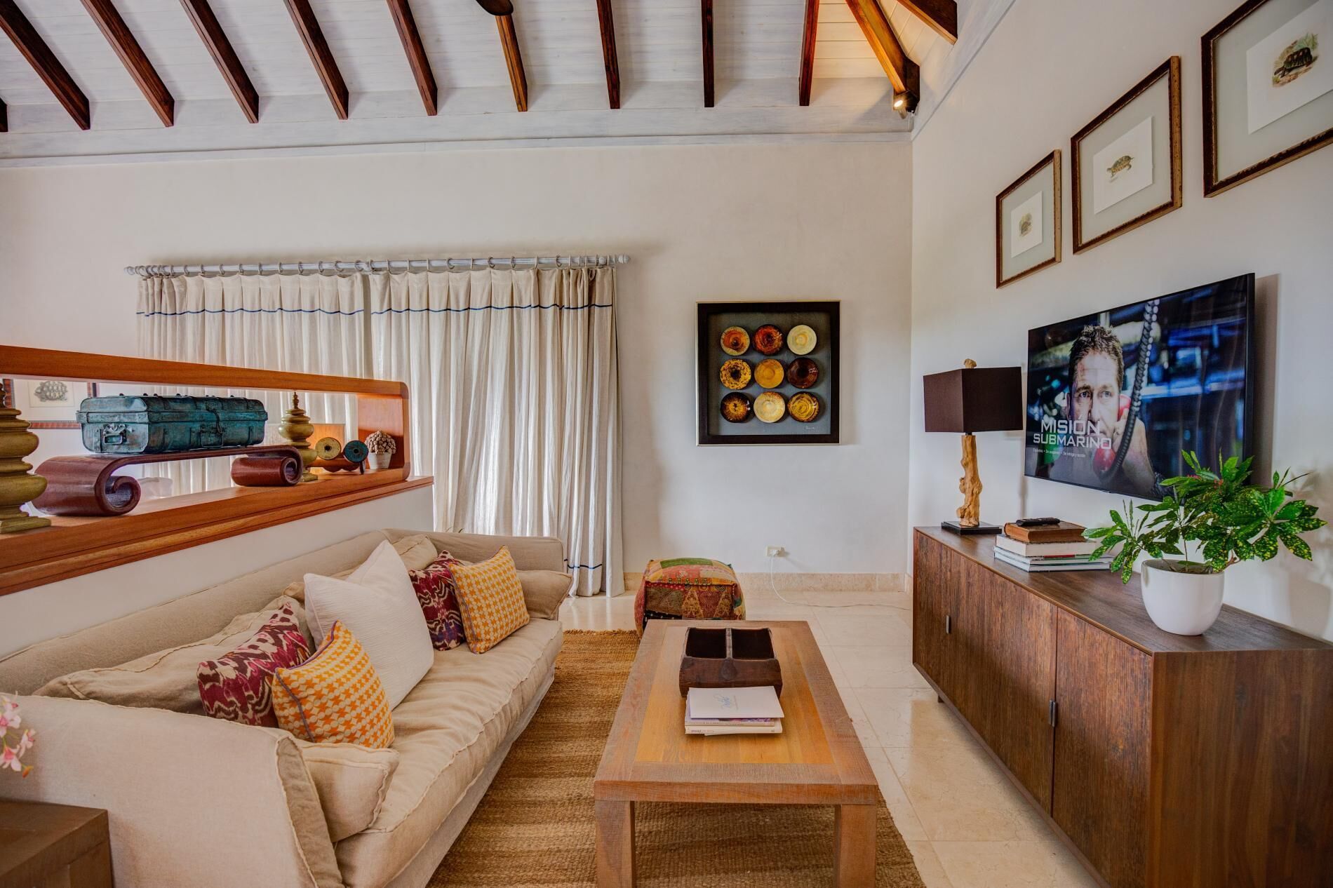 A living room with a sofa, a television, and a wood cabinet.