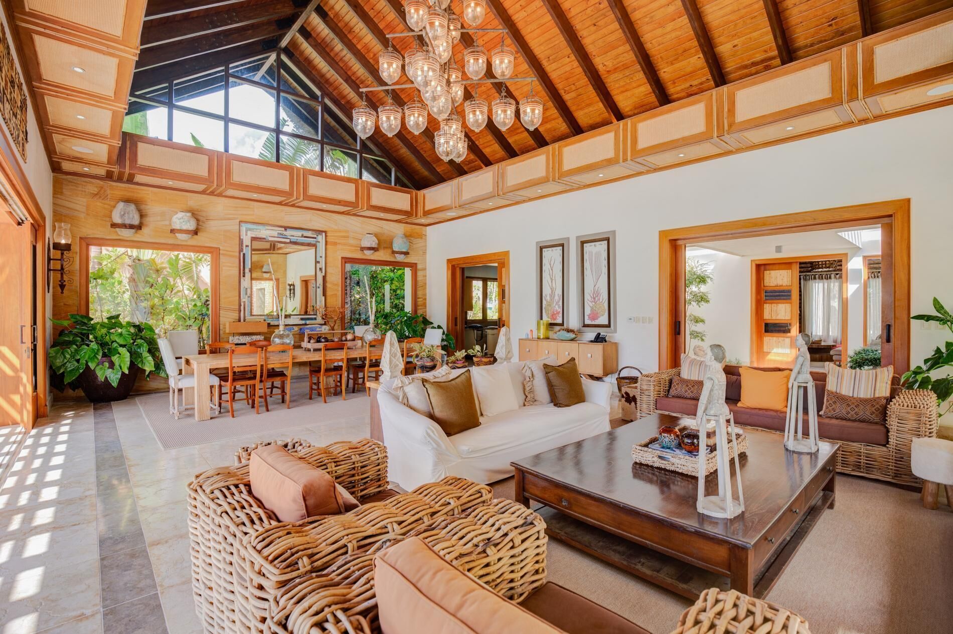 The main living room with sofas, a dining table, and a chandelier.