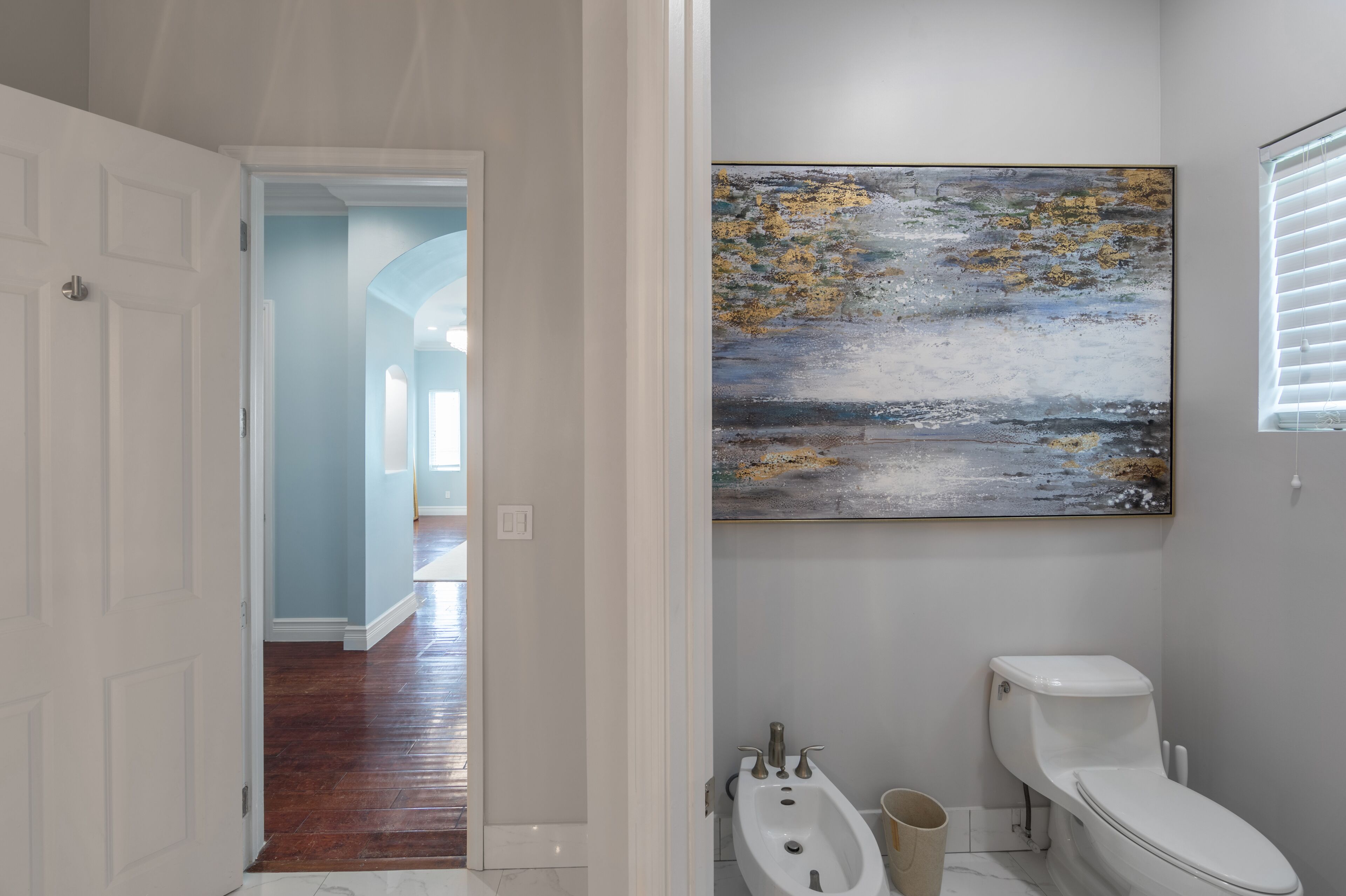 A bathroom with a toilet and a bidet.