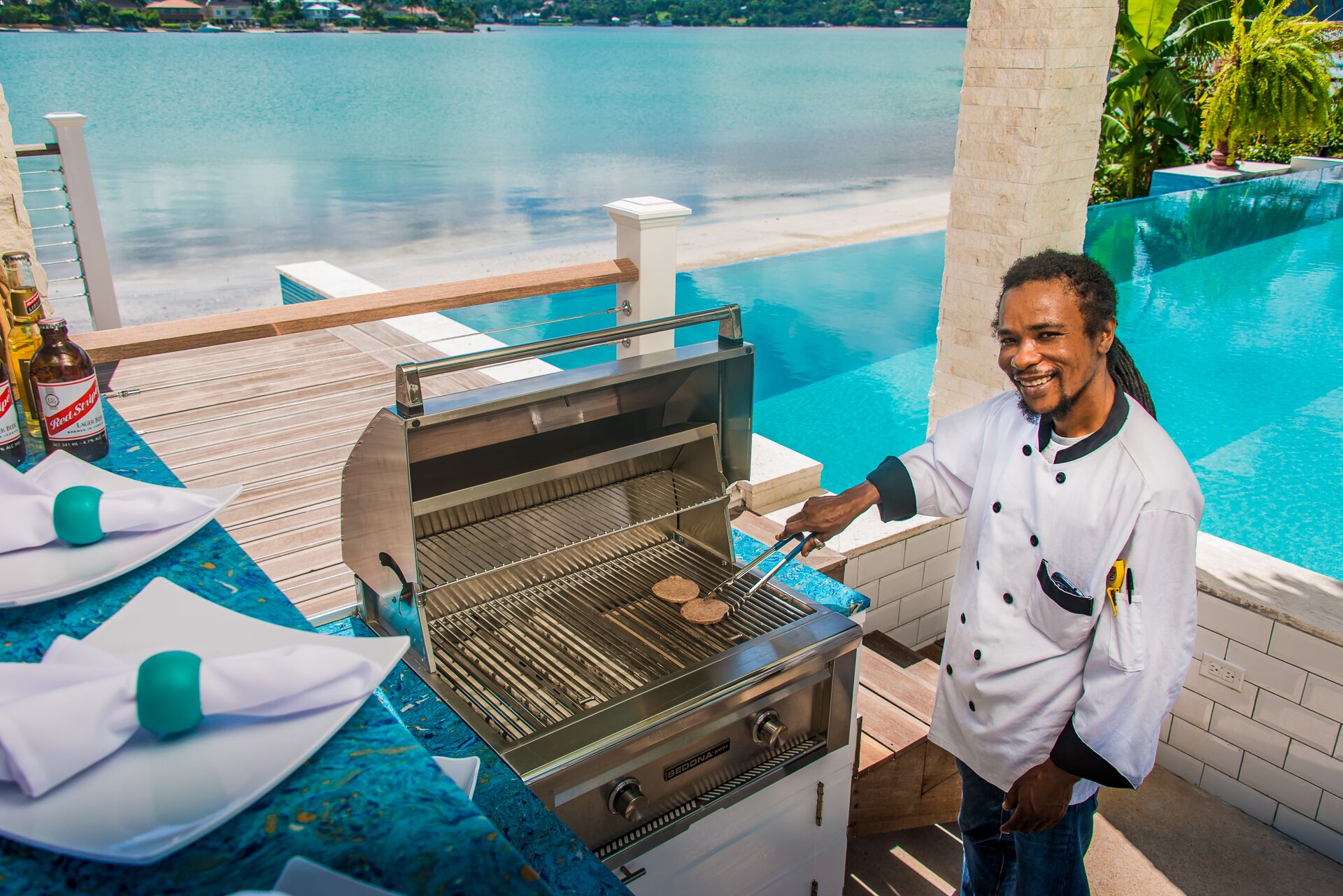 A chef at the grill by the pool.