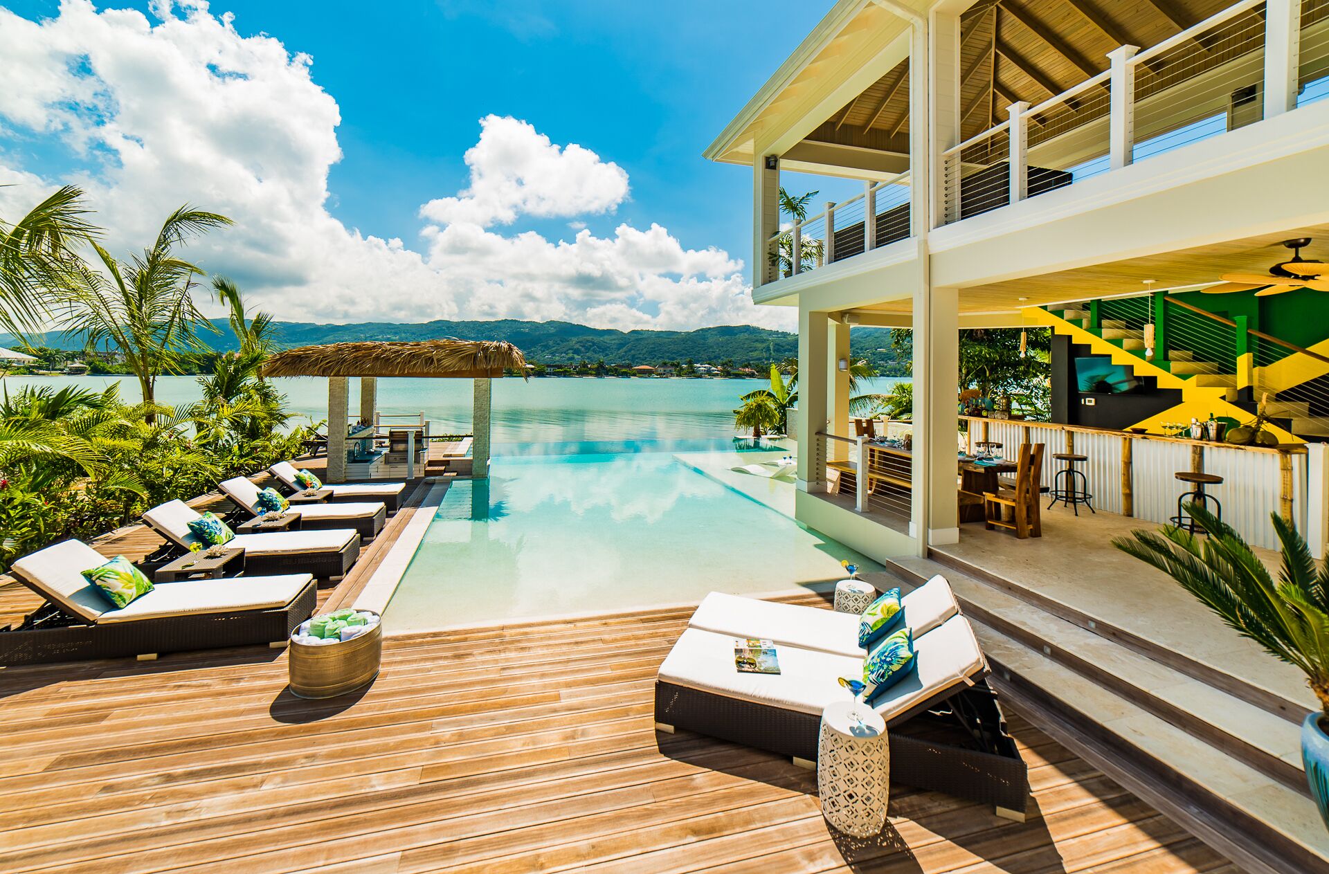 The pool deck with loungers and the covered bar.