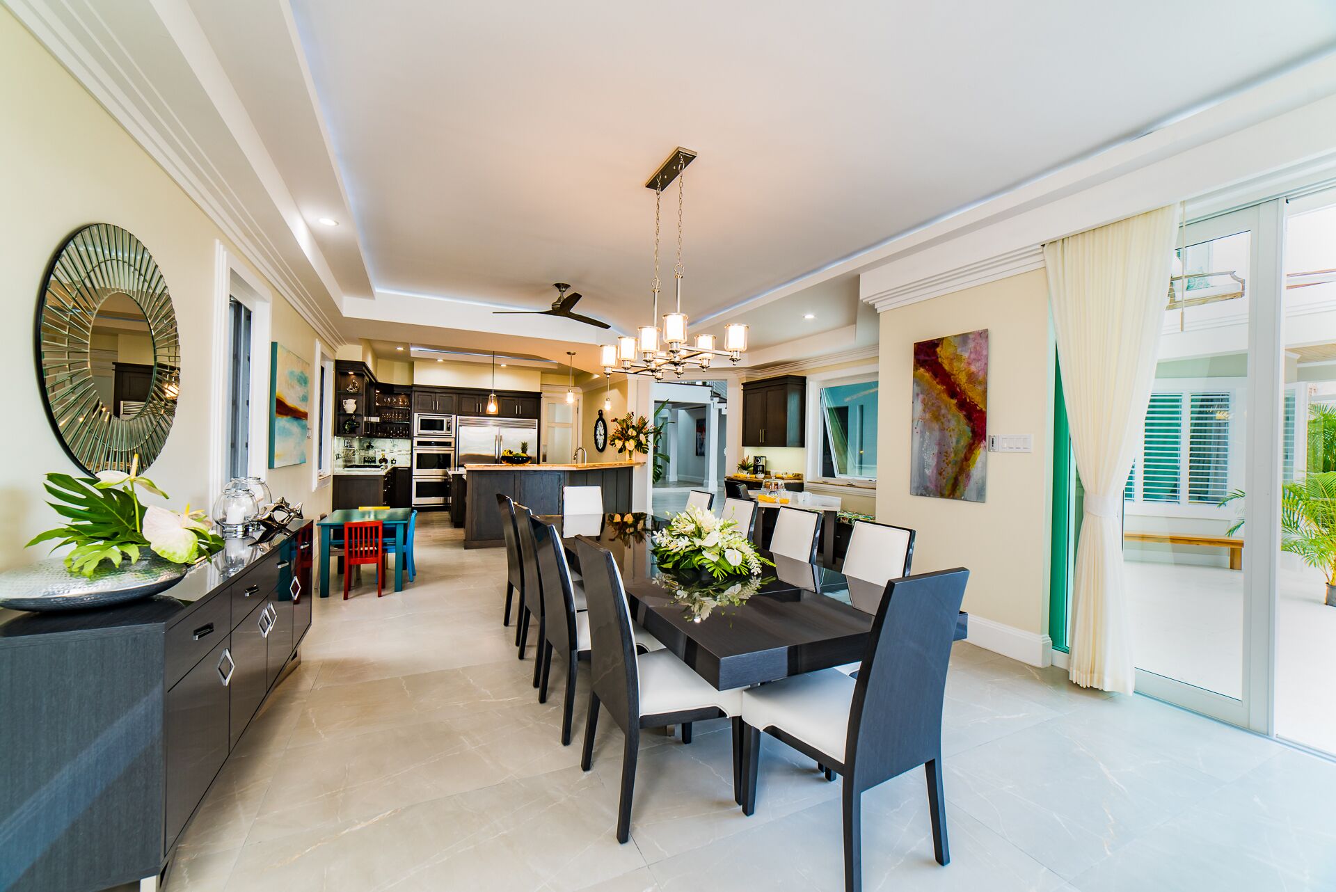 The dining room with a long table and flowers.