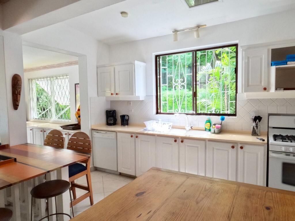 A kitchen with white cabinets, a gas stove, and a dishwasher.