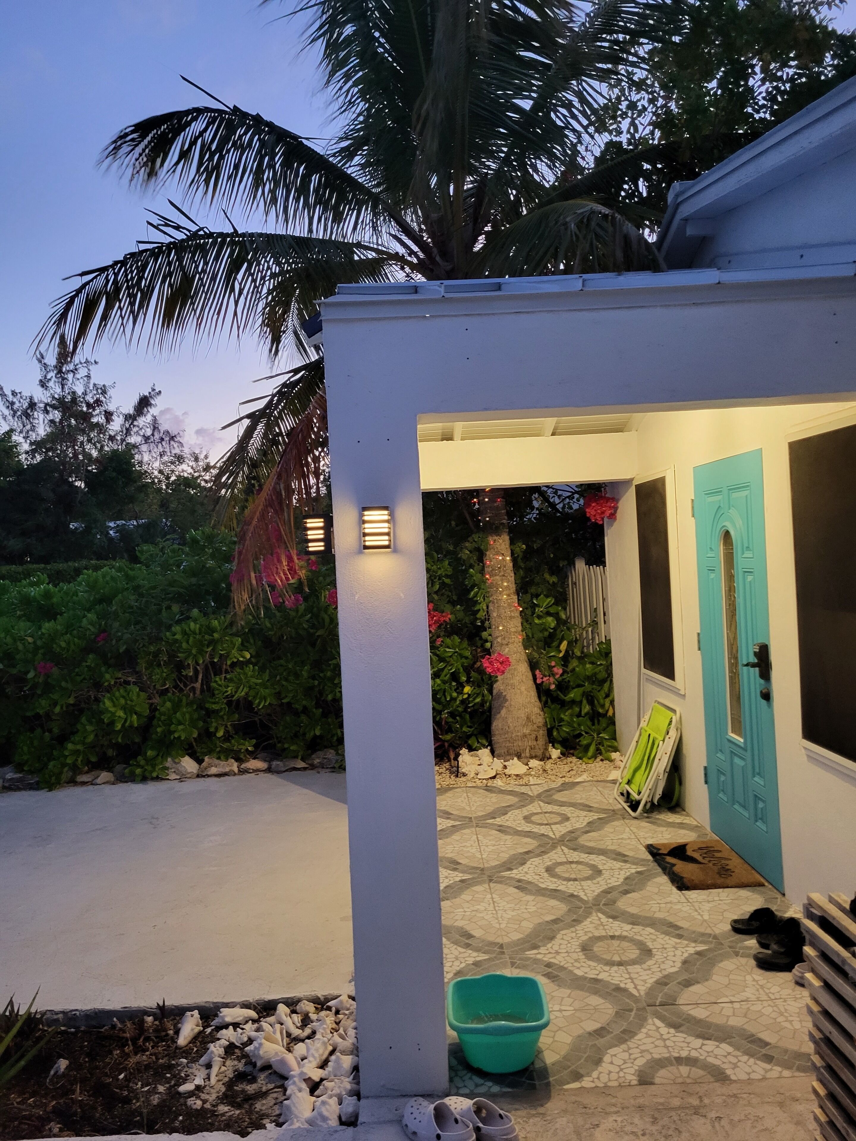 The lighted entrance of the villa in the evening.