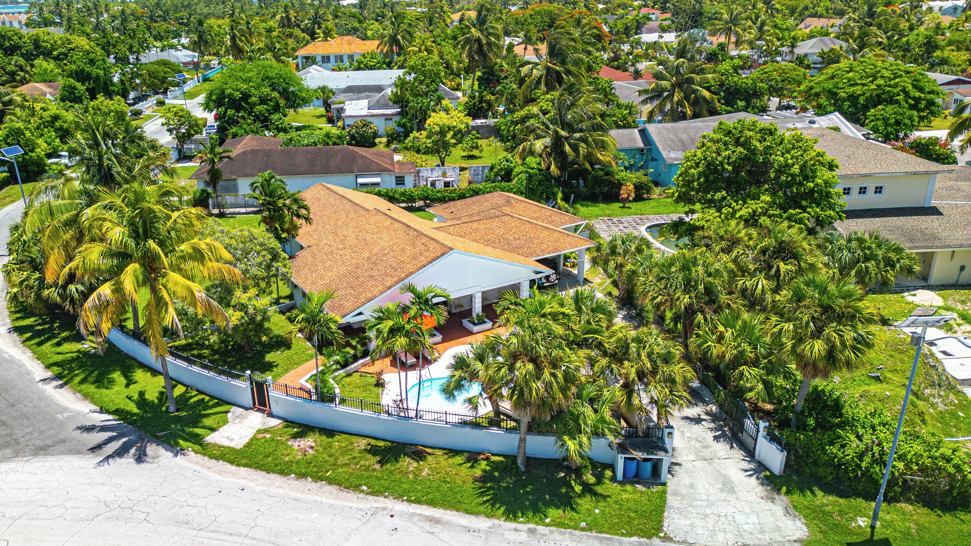An aerial view of the house, the pool, and the garden.