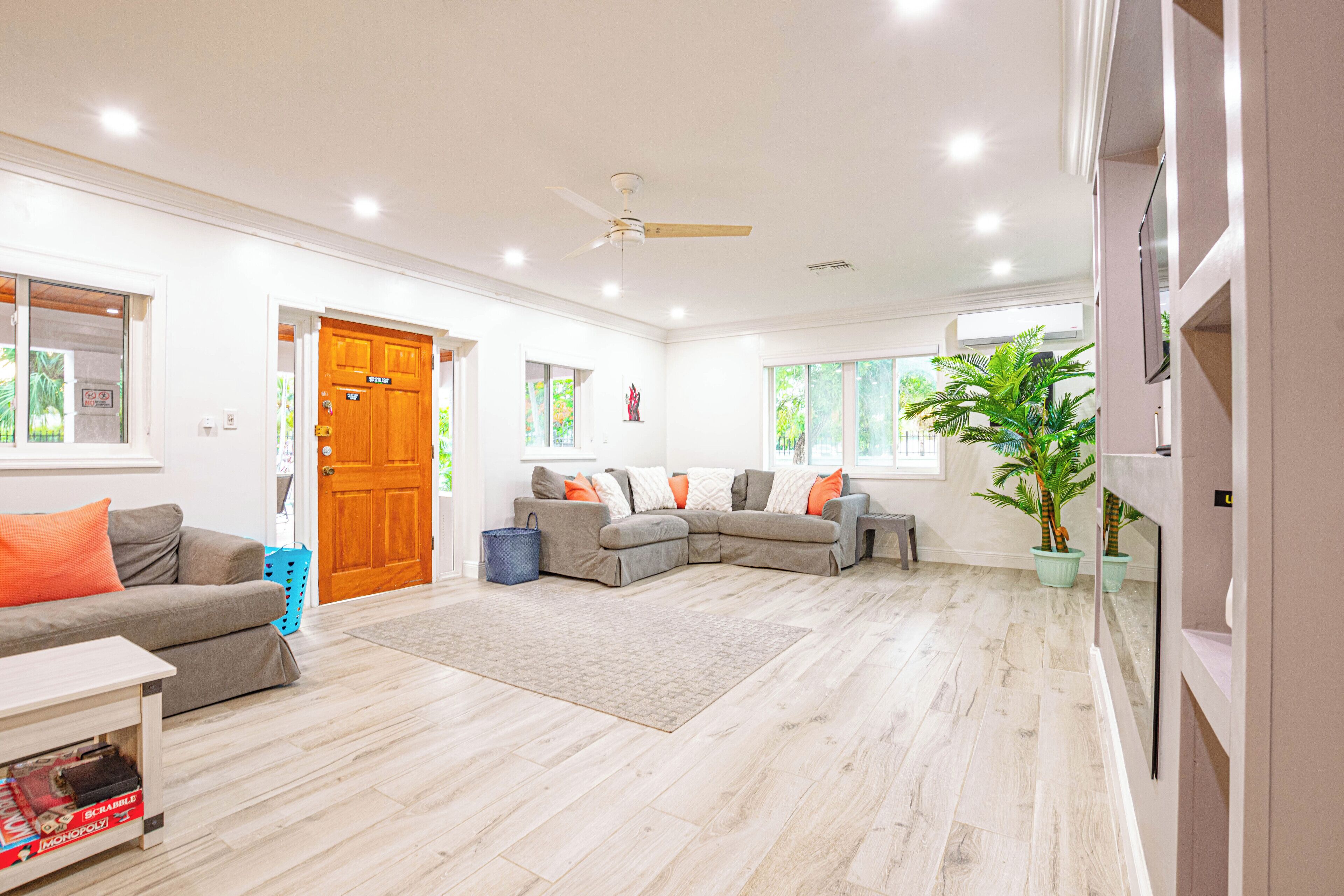 A living room with two gray sofas and a ceiling fan.