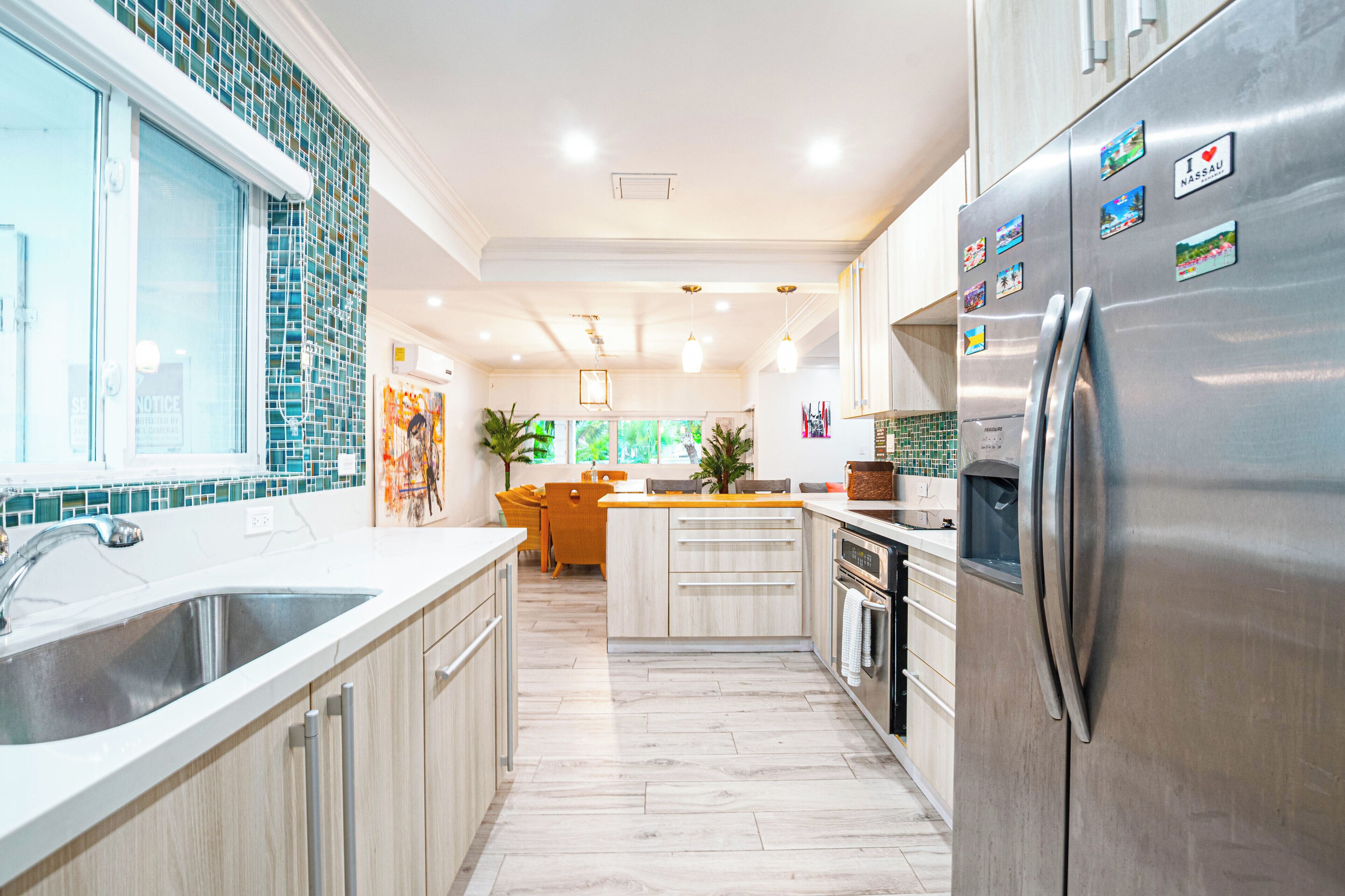 The kitchen with a steel refrigerator and white counters.