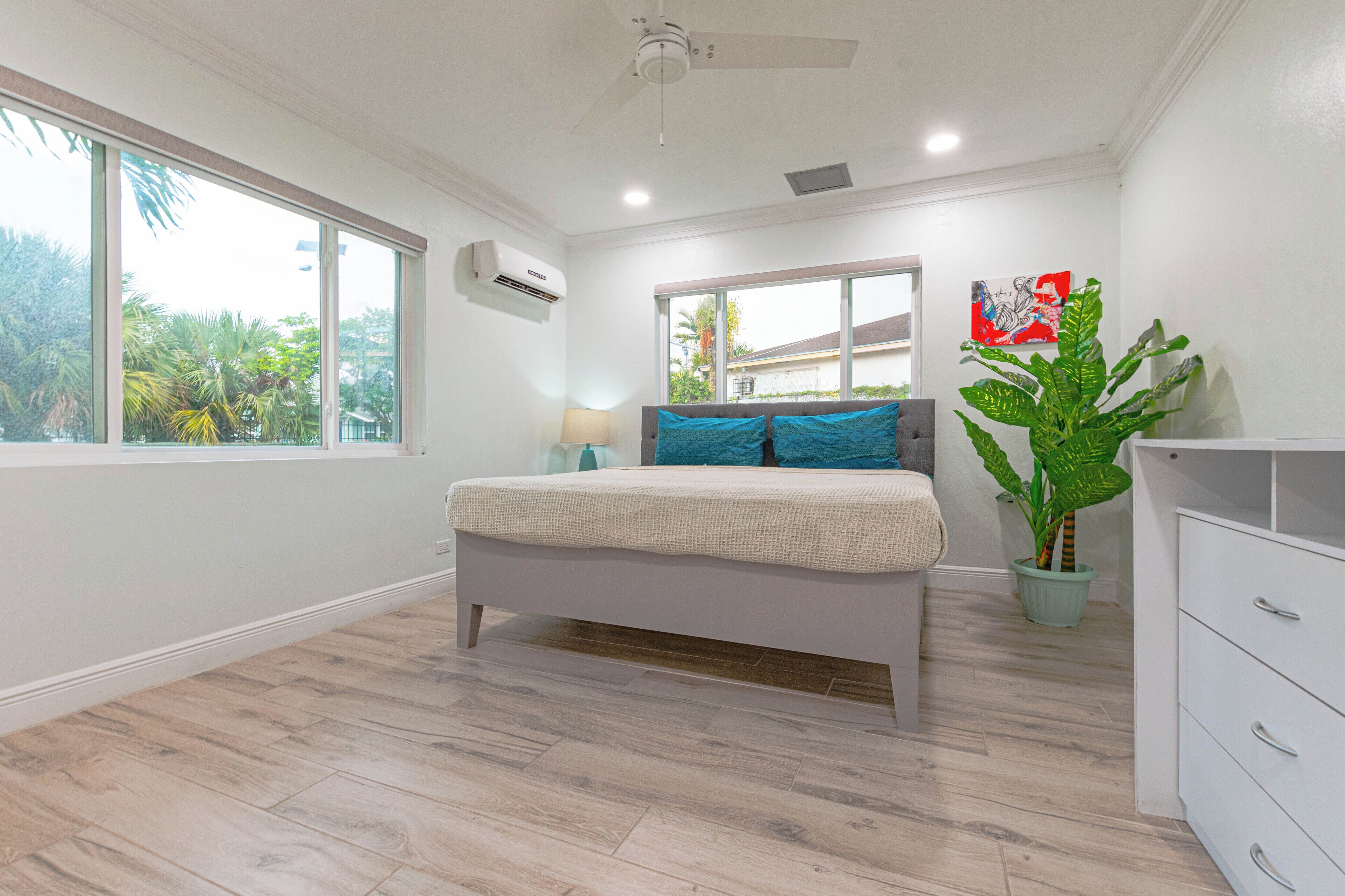 A bedroom with a double bed and blue pillows.