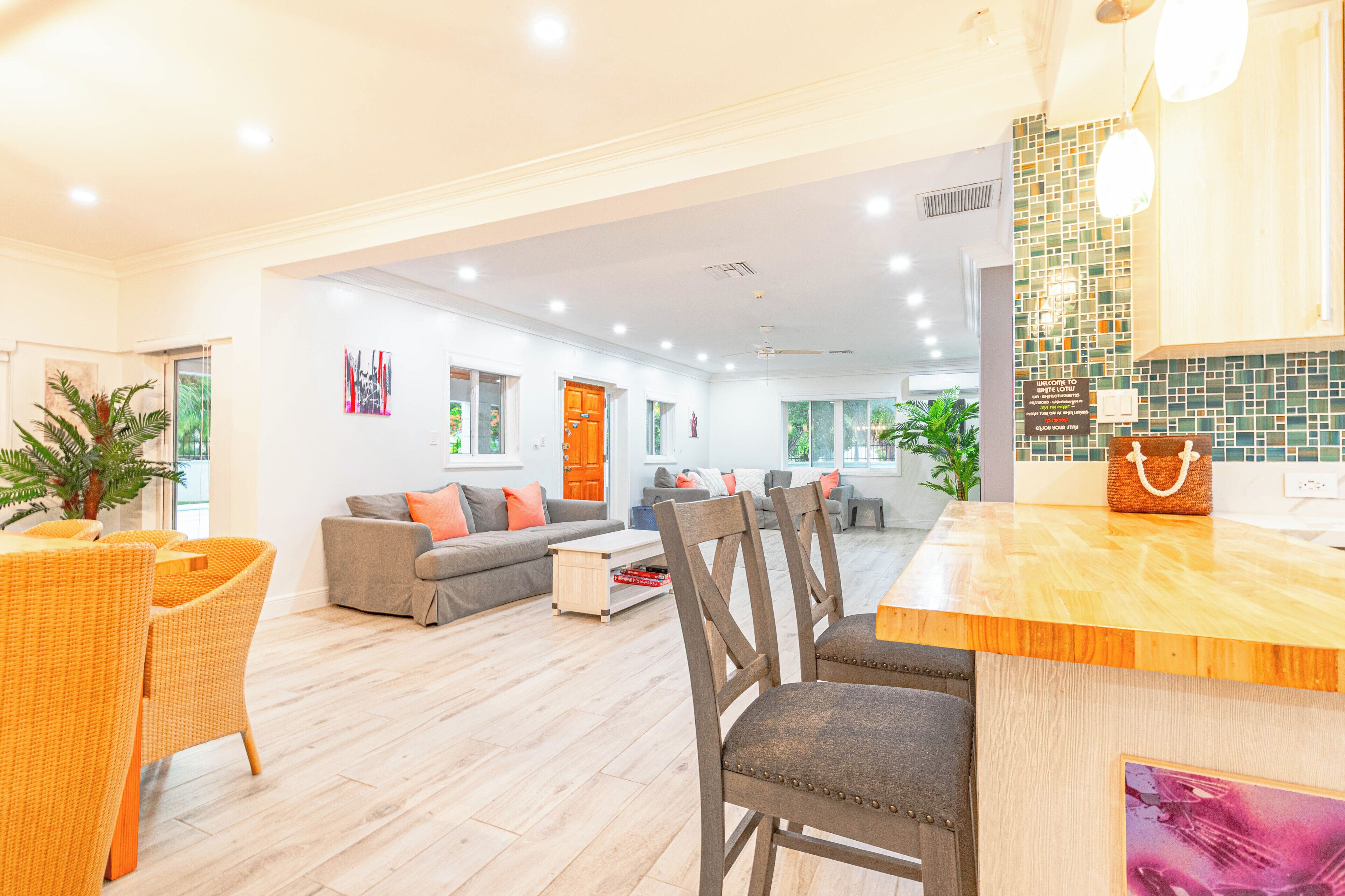 The living area with a dining table and a kitchen counter.