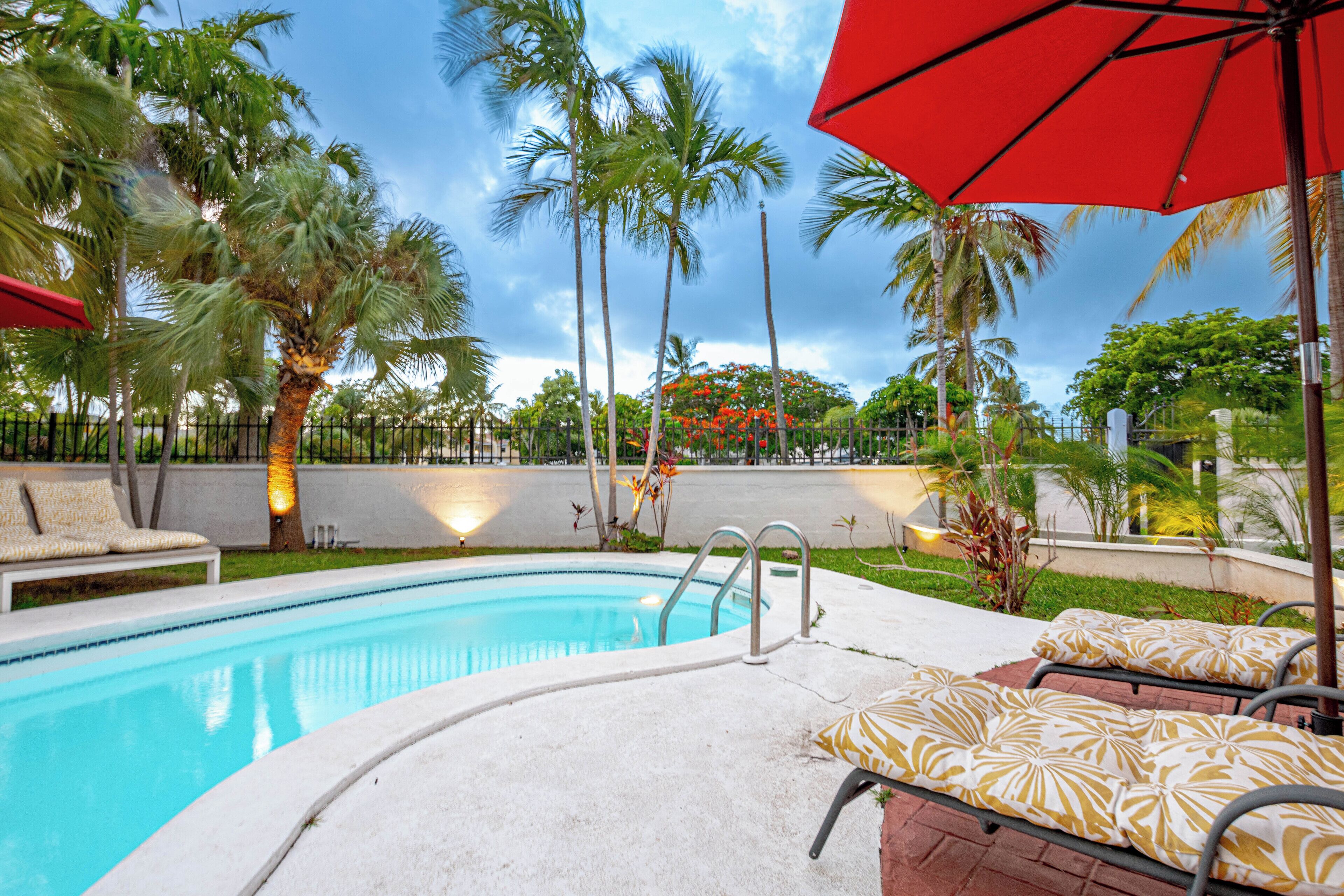 The pool with palm trees around it.