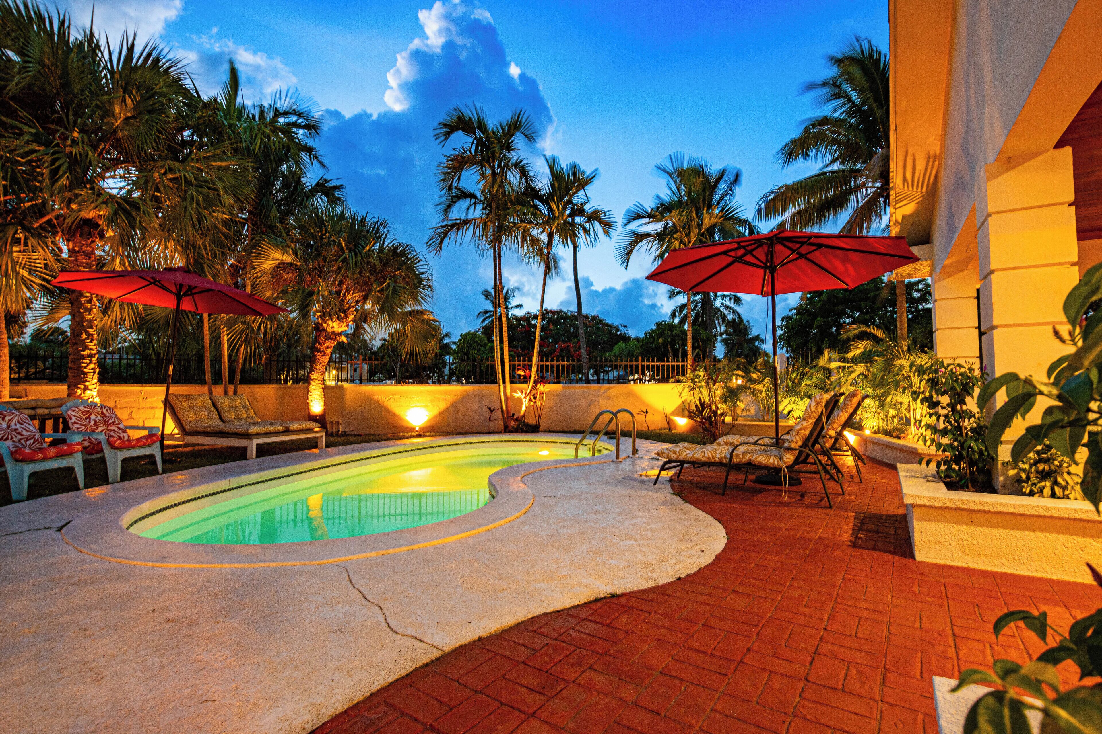The pool with an underwater light at dusk.