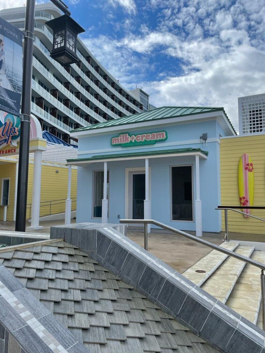 A small blue shop building in Nassau.
