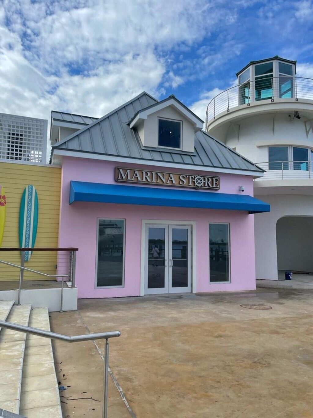 A pink shop building at a marina in Nassau.