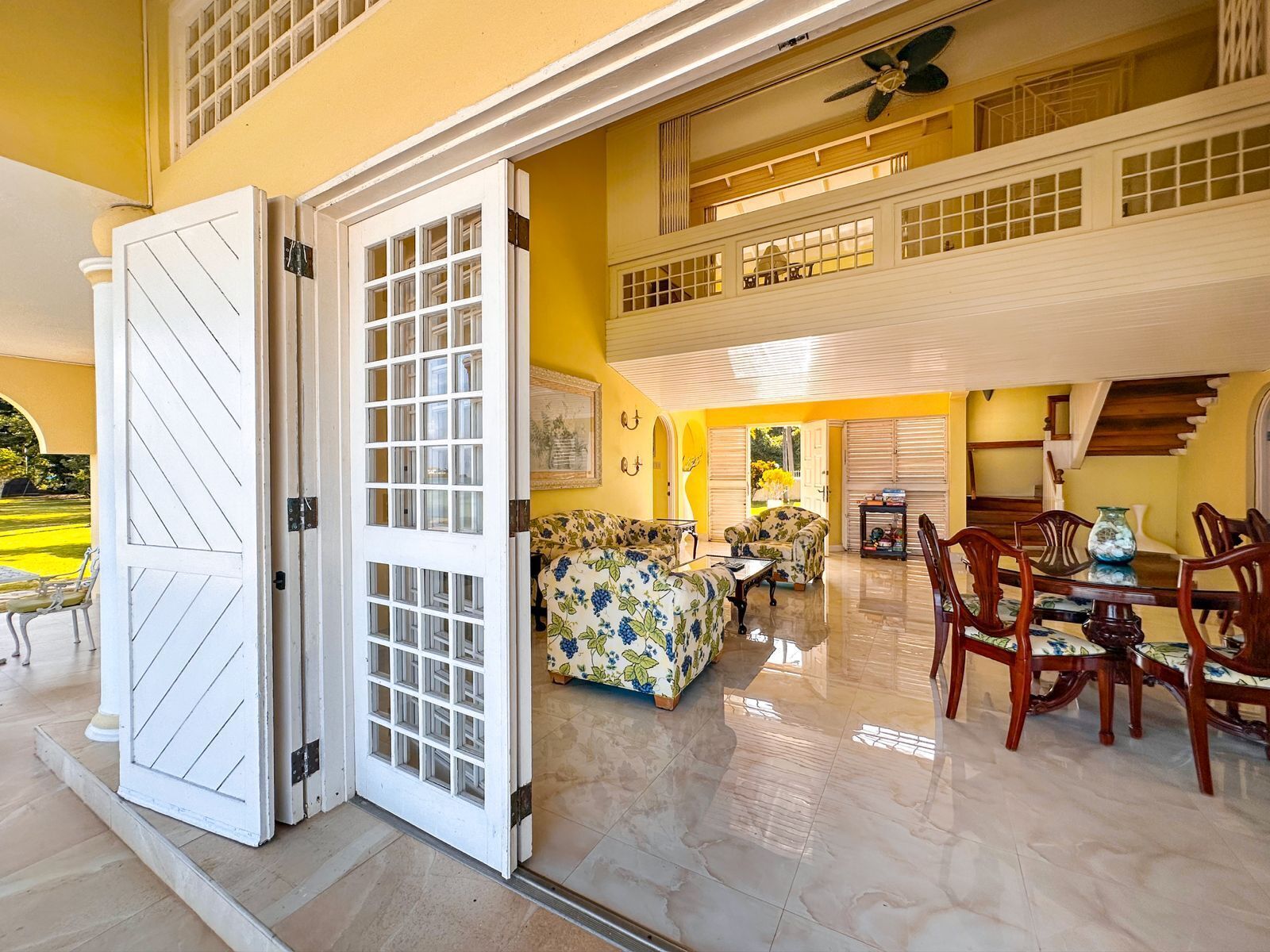 Open doors from the veranda into the living room and the dining area.