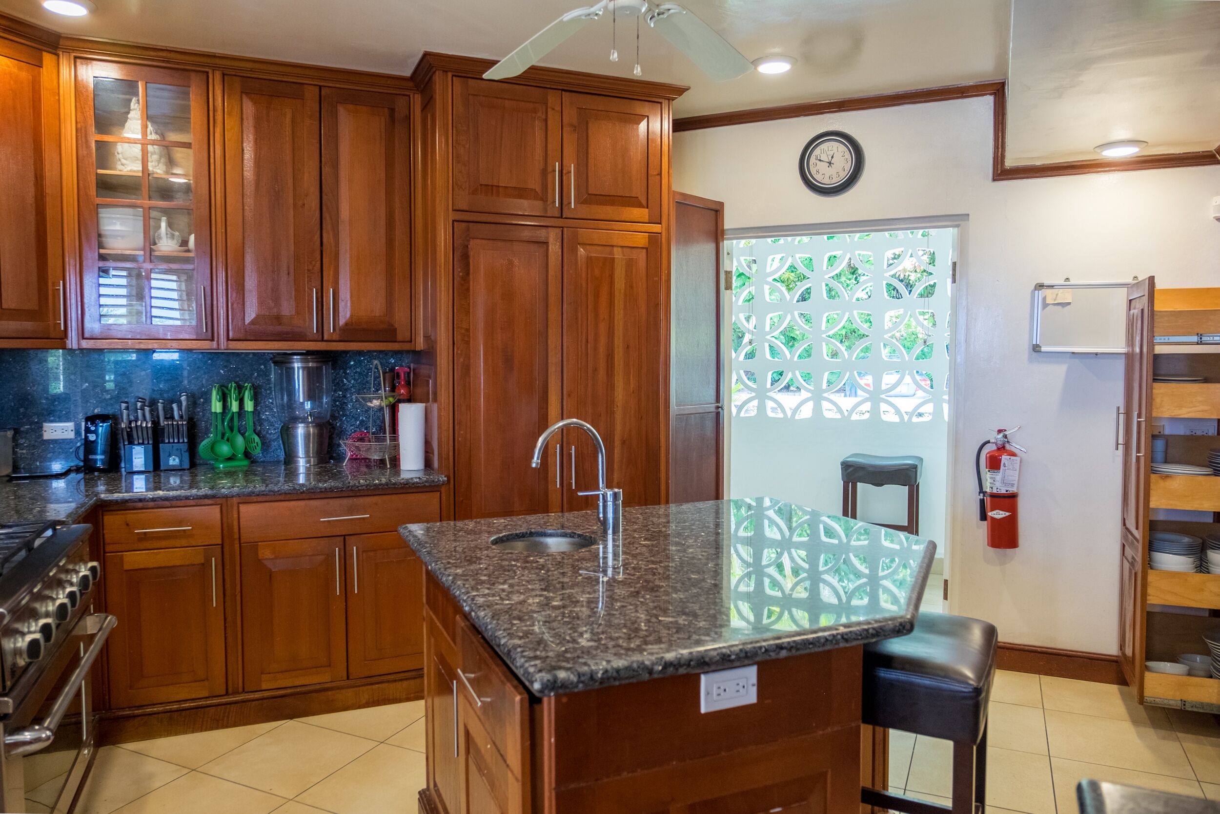 The kitchen with wood cabinets, a granite counter, and a center island.