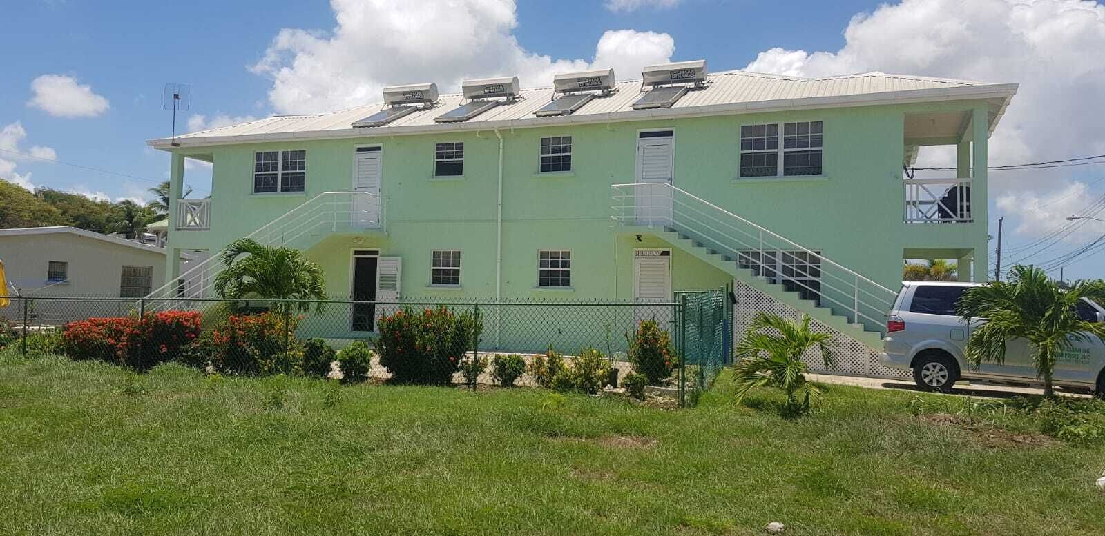 The rear of the apartment building, with stairs and solar water heaters.
