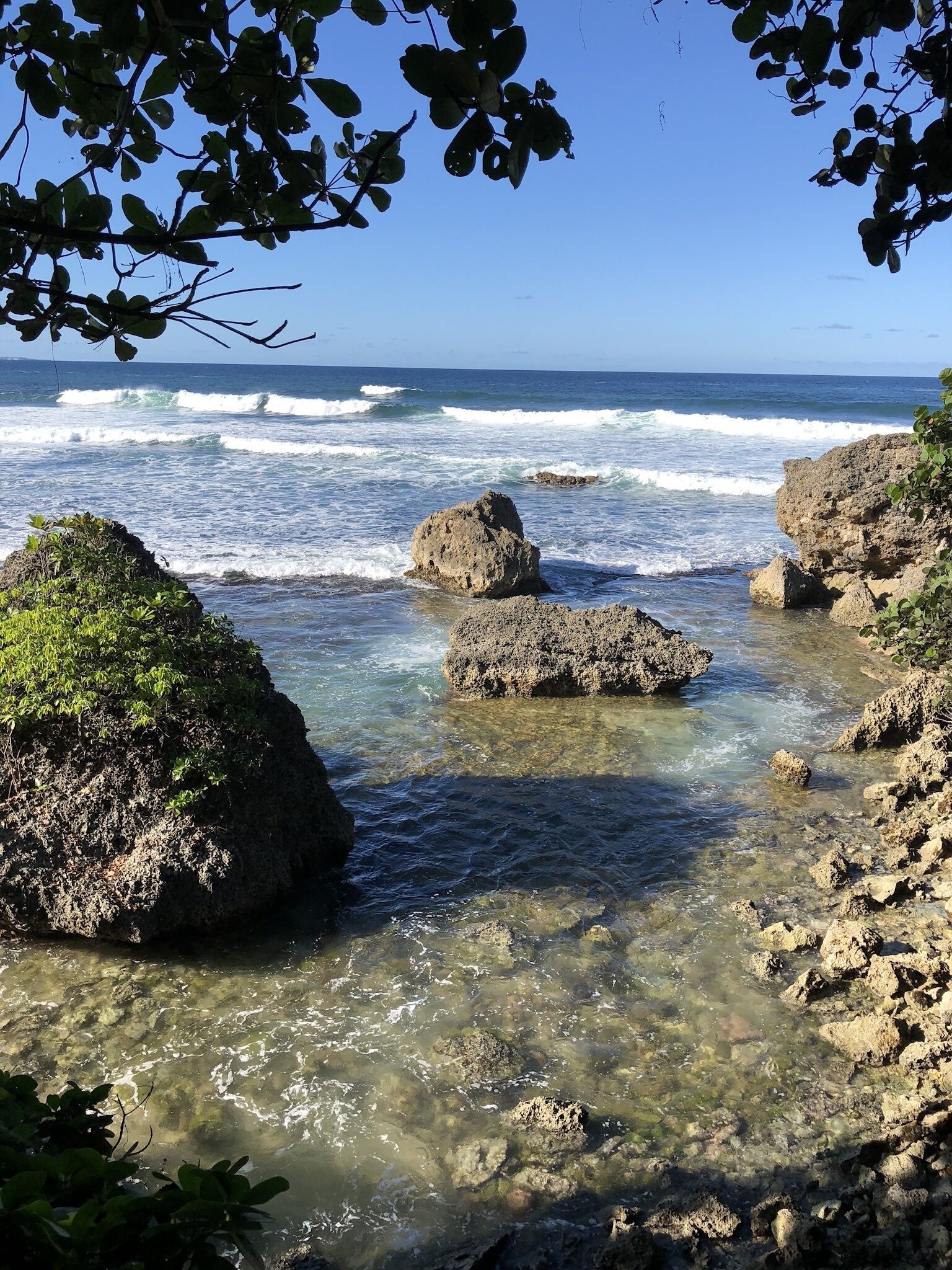 Waves break on rocks along the shore.