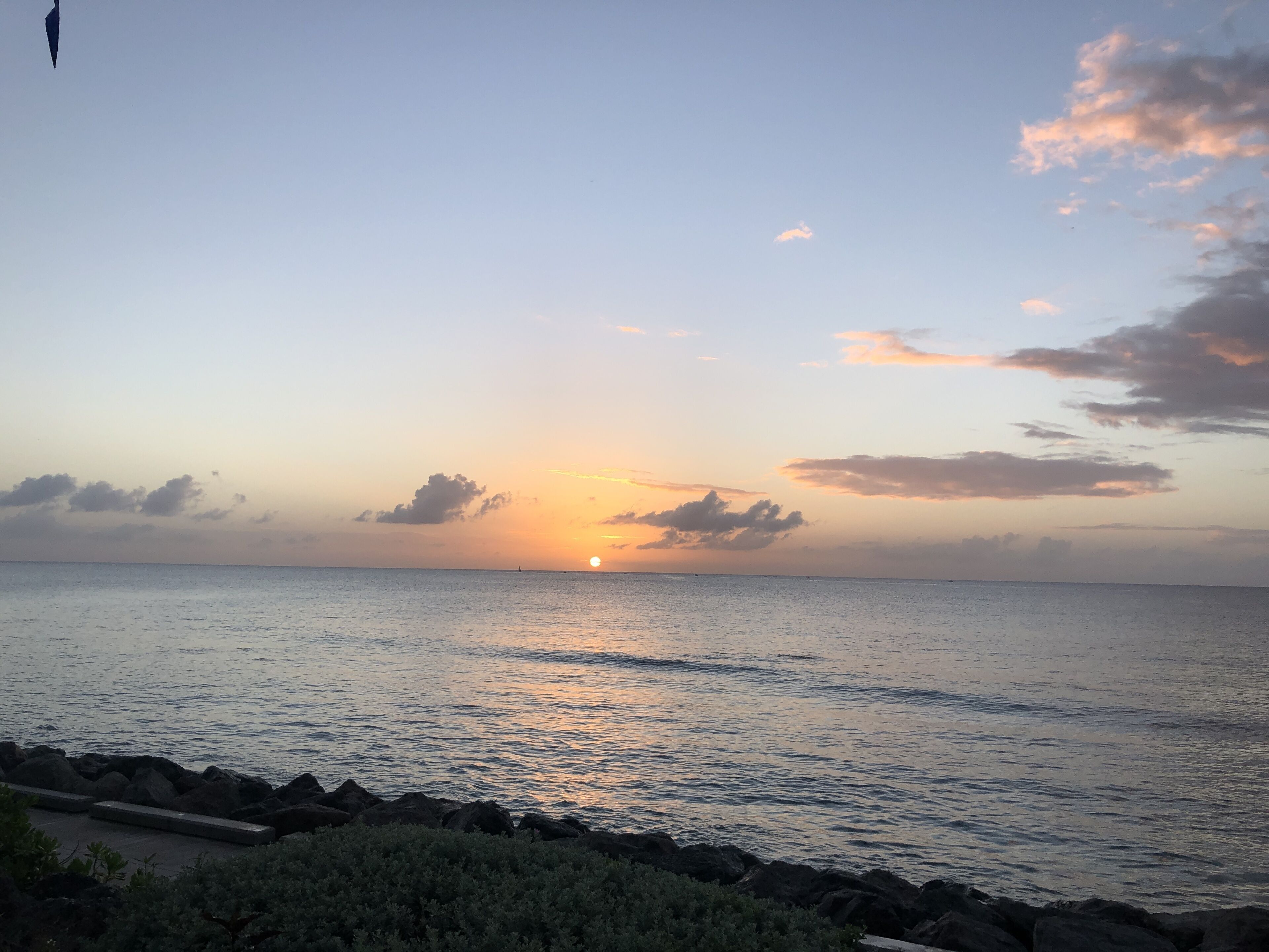 A sunset over a calm sea.