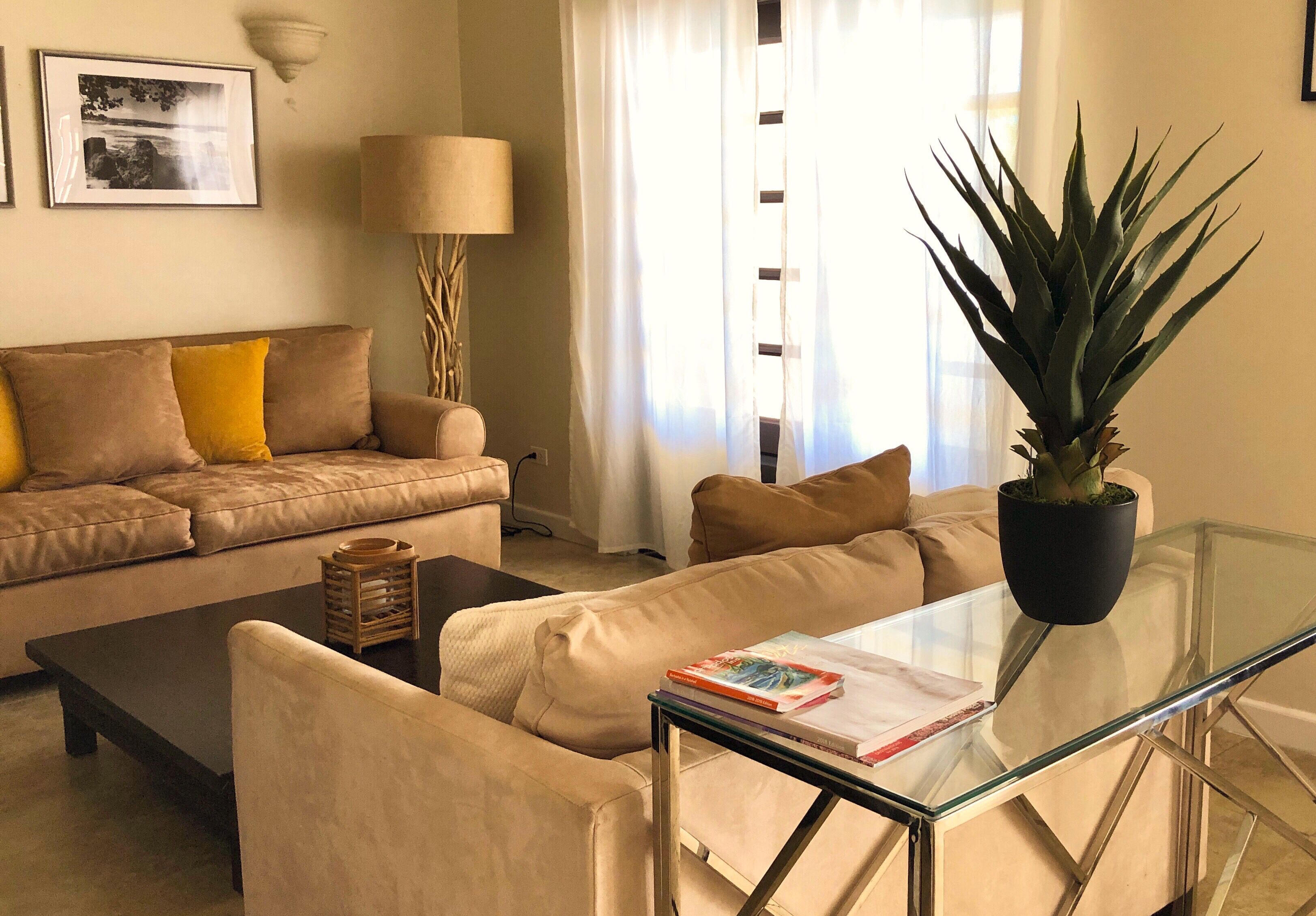 A living room with two sofas and a glass table.