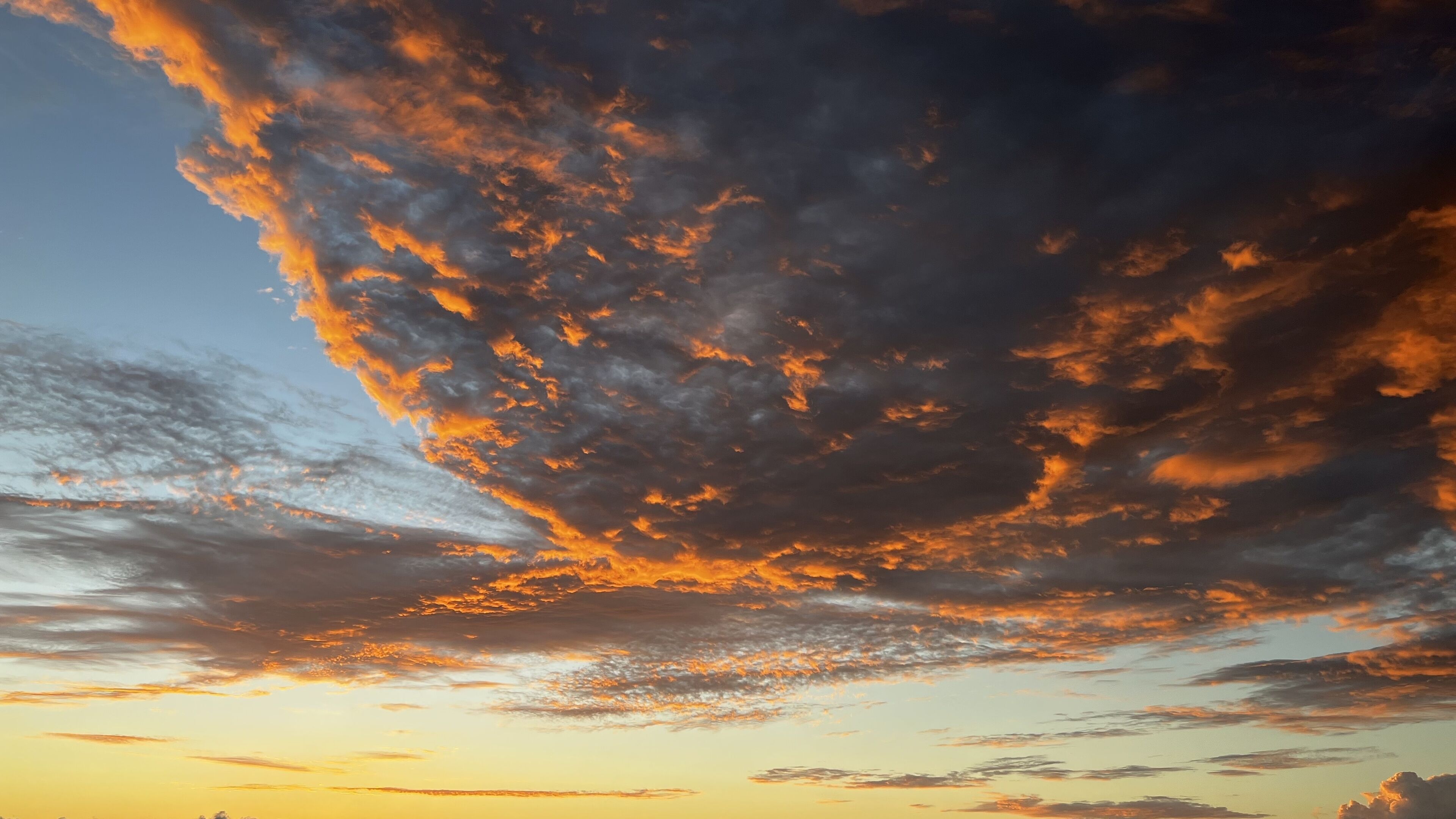 Orange clouds in the sky at sunset.