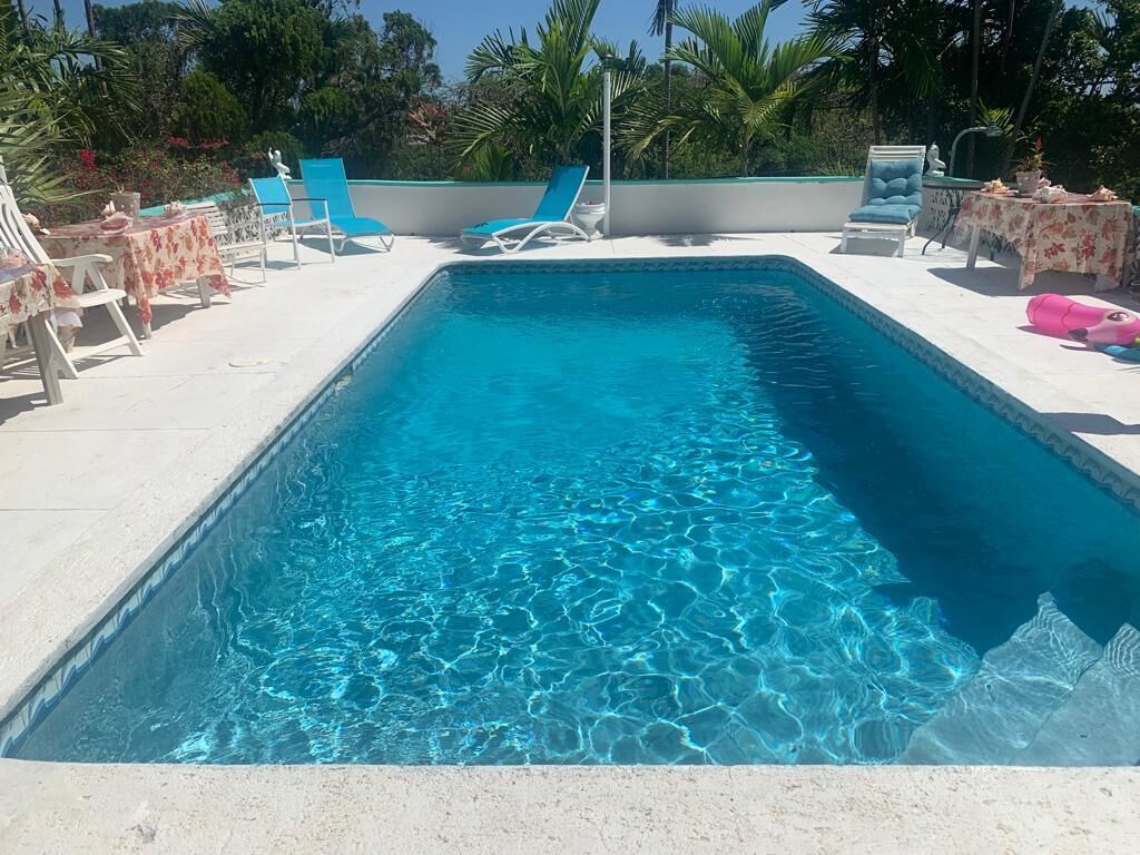 The pool with sun loungers on the terrace.