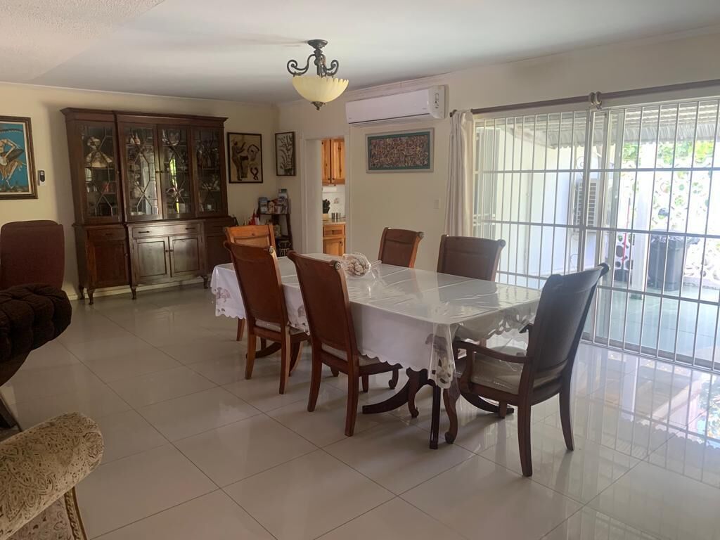 A dining area with a table and a china cabinet.