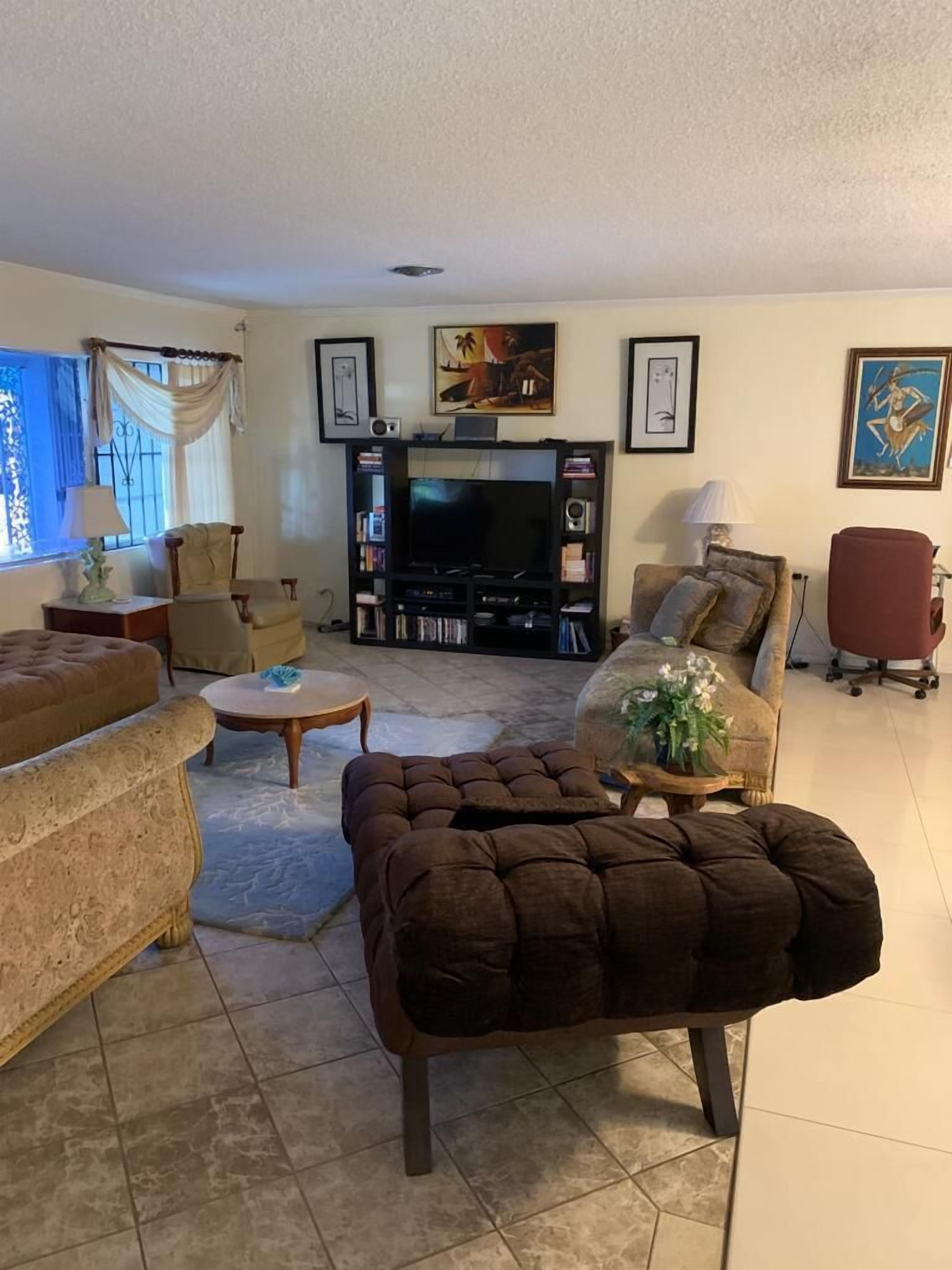 A living room with sofas and a television.