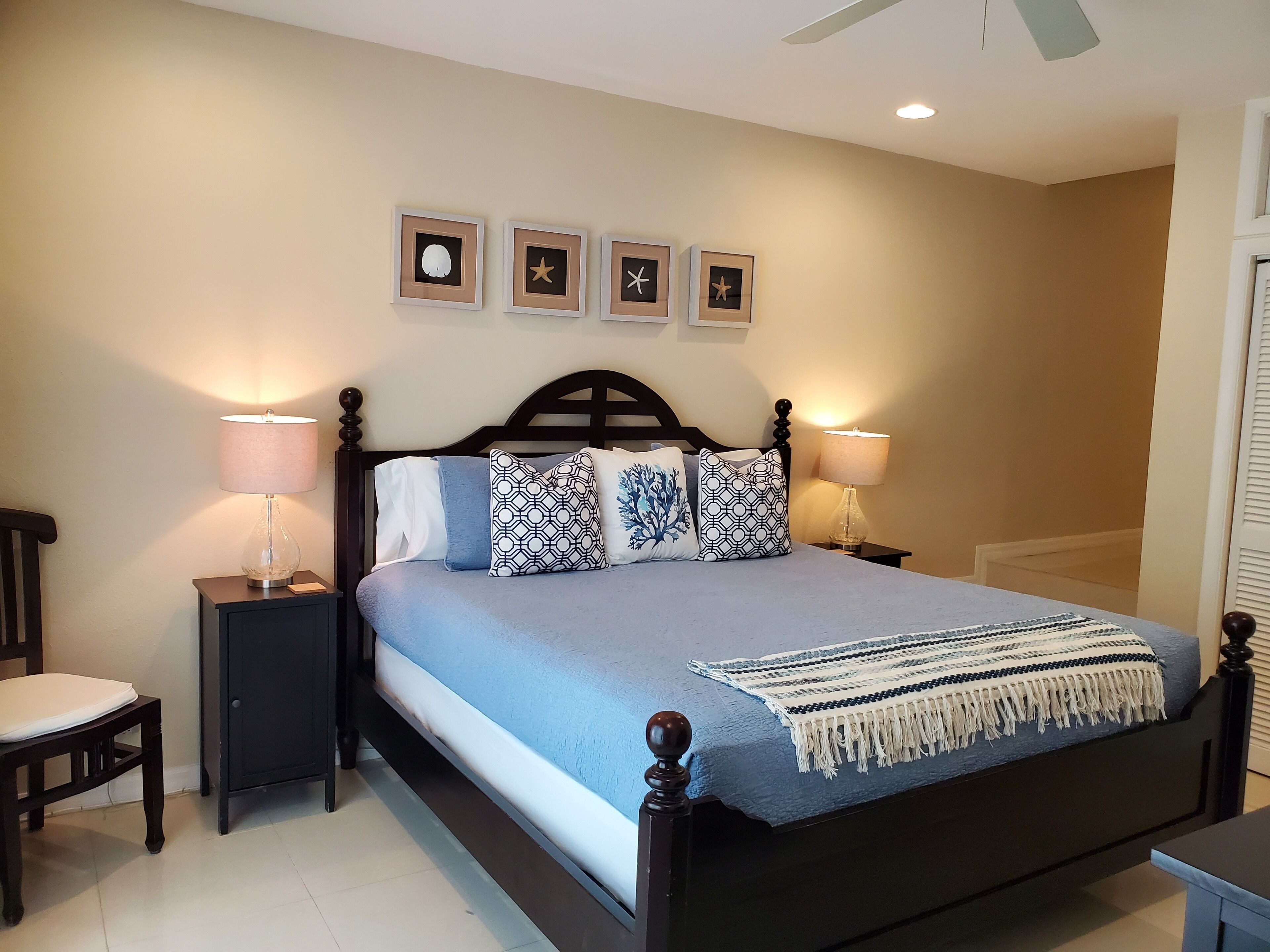 A bedroom with a dark wood bed and two bedside lamps.