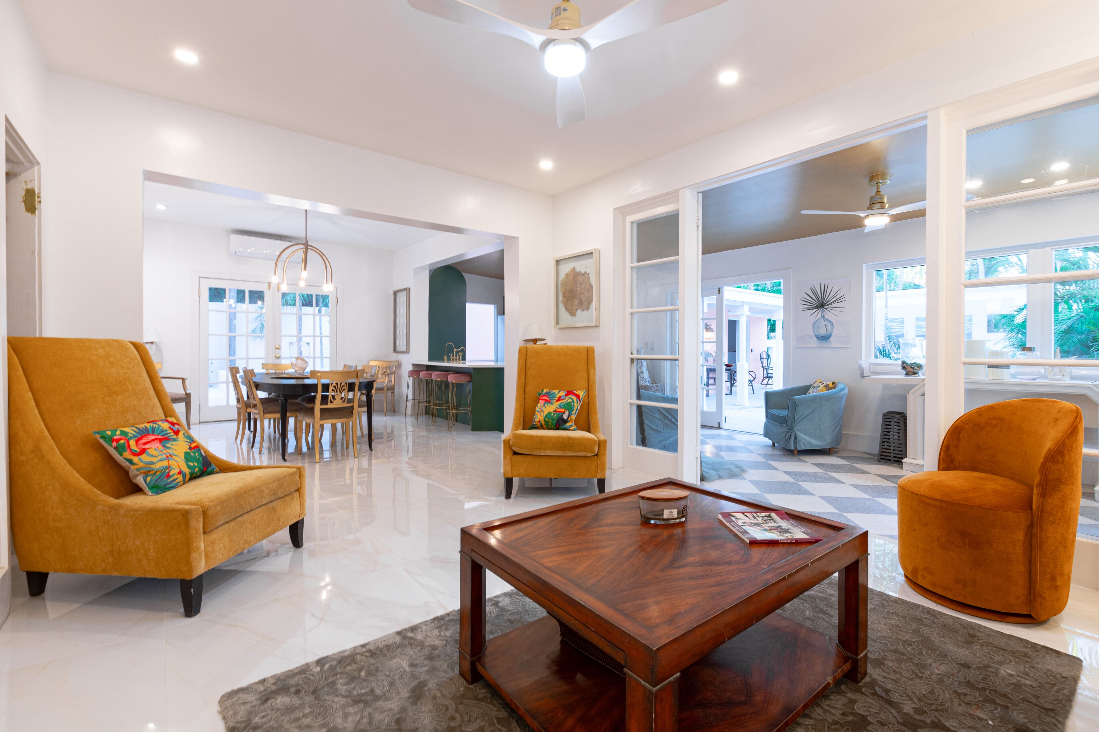 The living room with two mustard chairs and a wood coffee table.