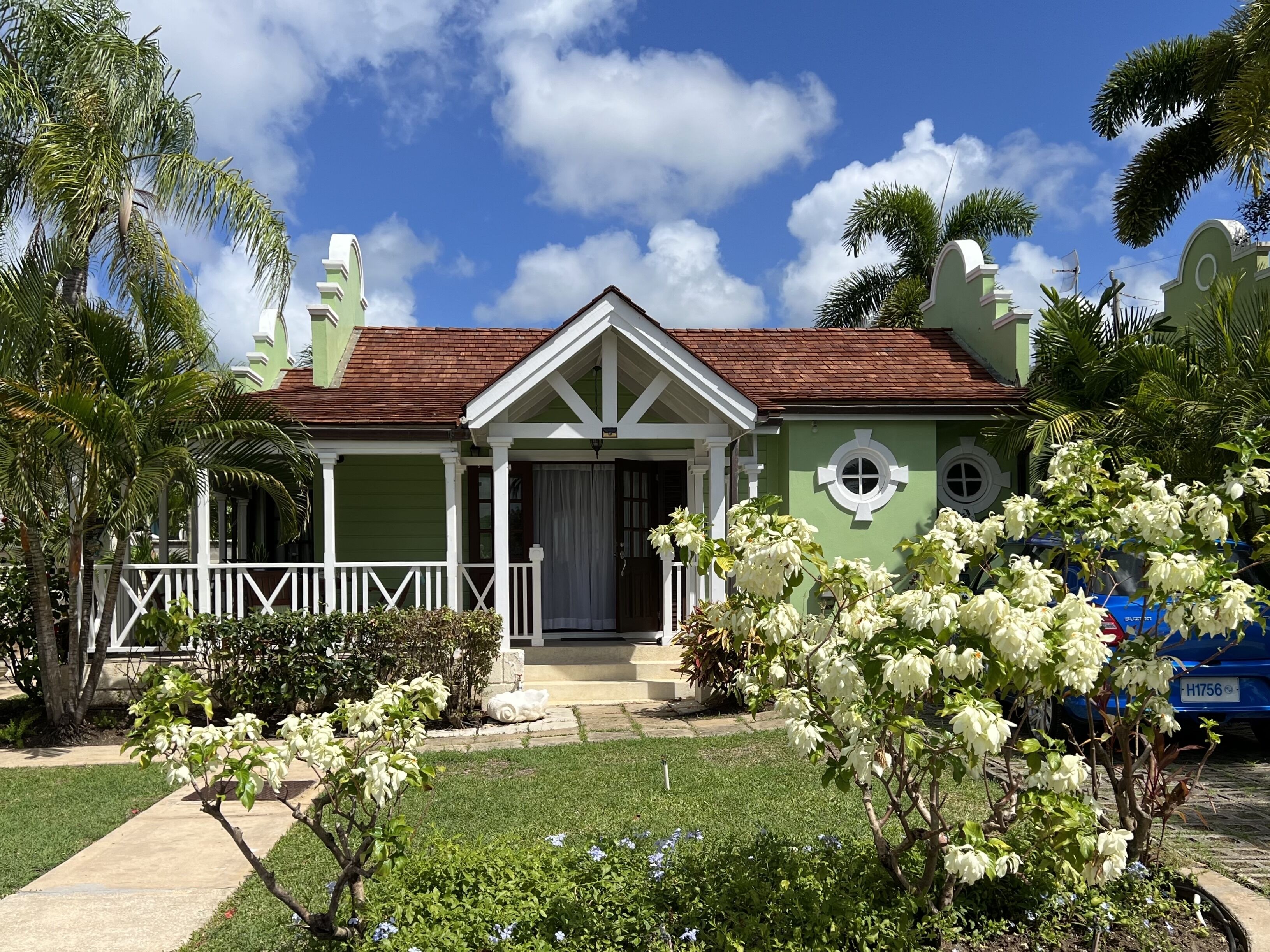A view of the green cottage and the garden from the path.