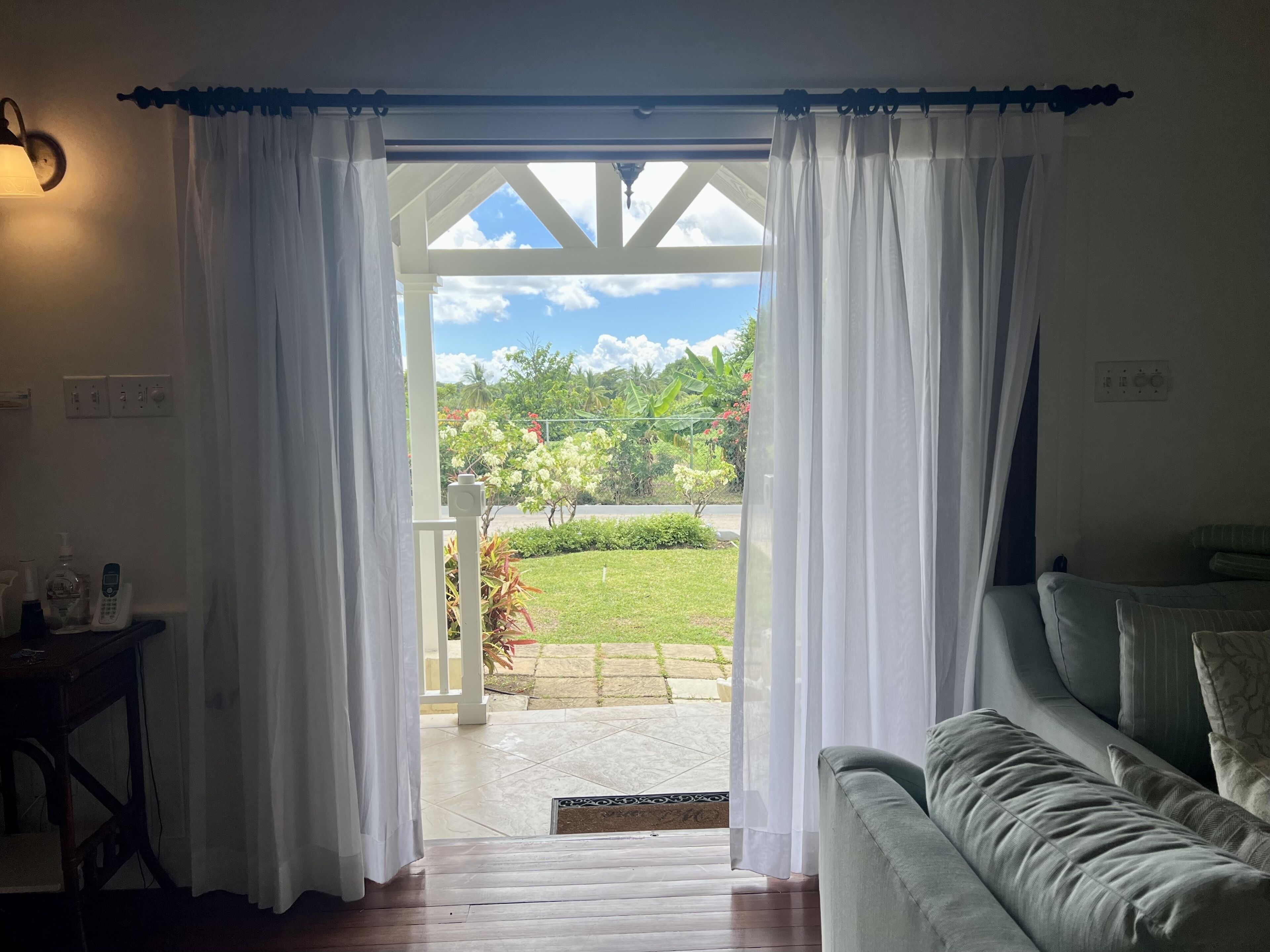 A view through the open doors to the porch and the garden.
