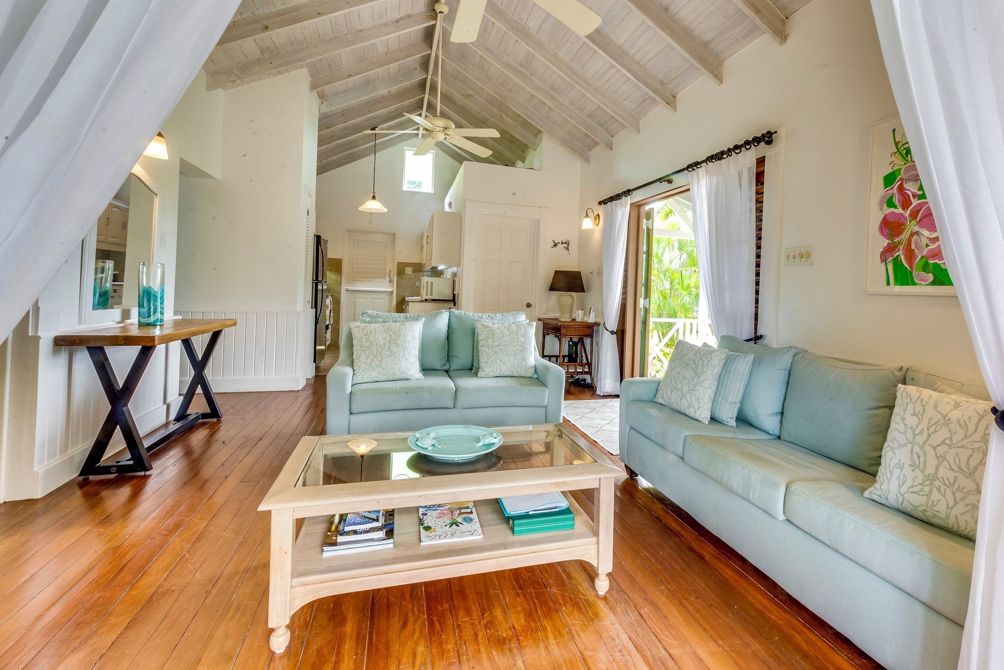 A living room with two sofas and a glass coffee table.