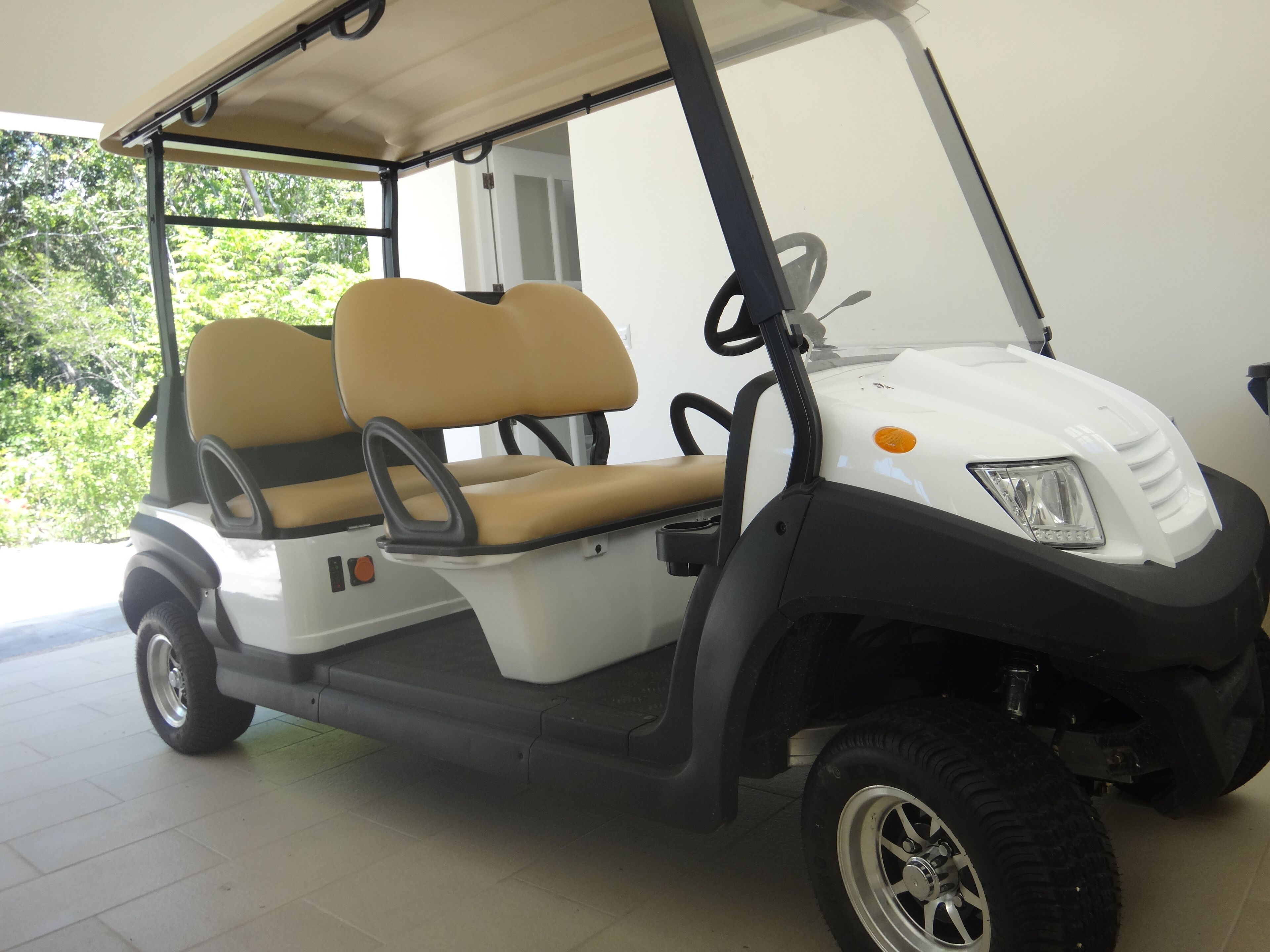 A golf cart in the carport of the villa.