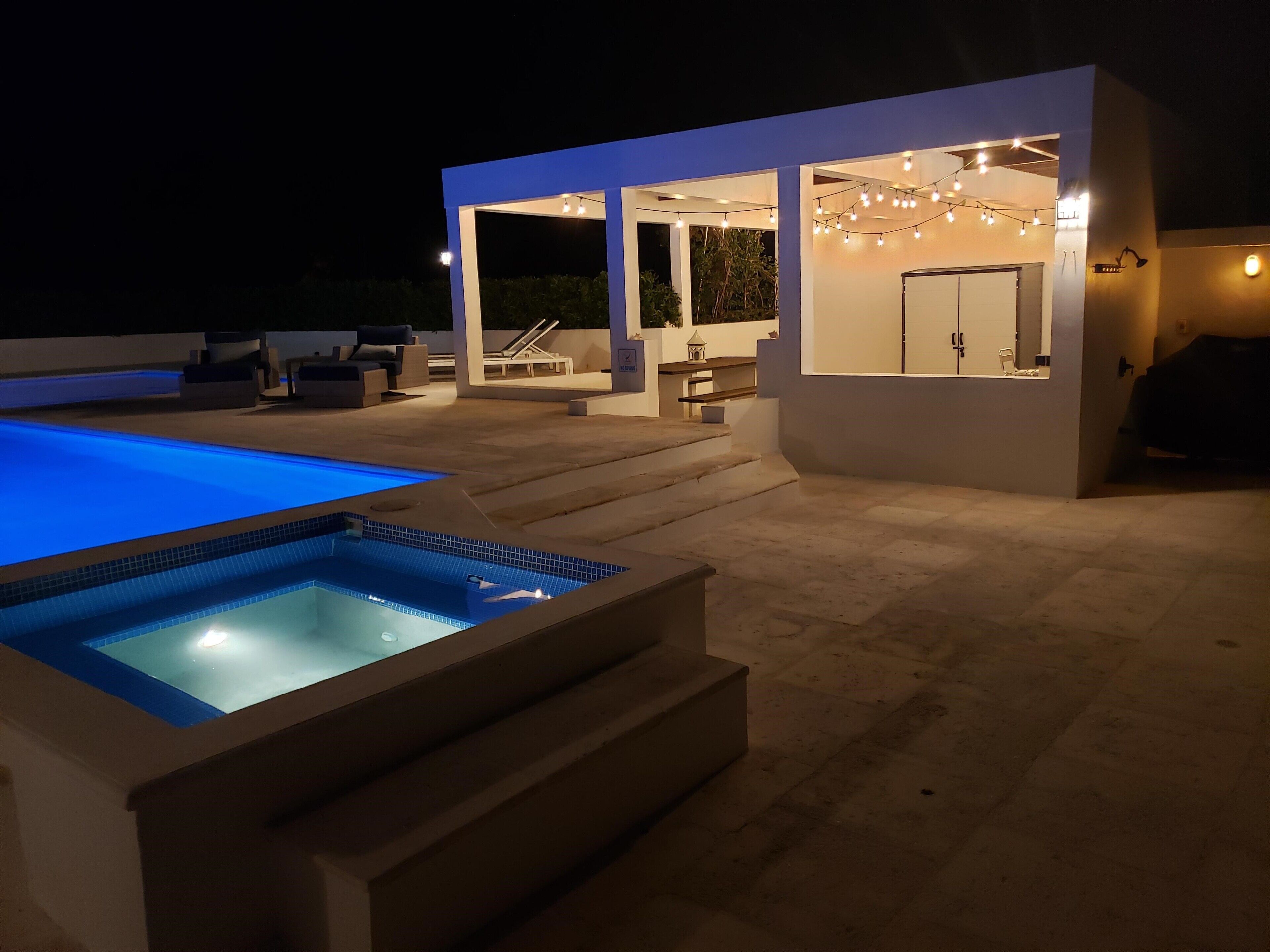The pool and the hot tub at night.