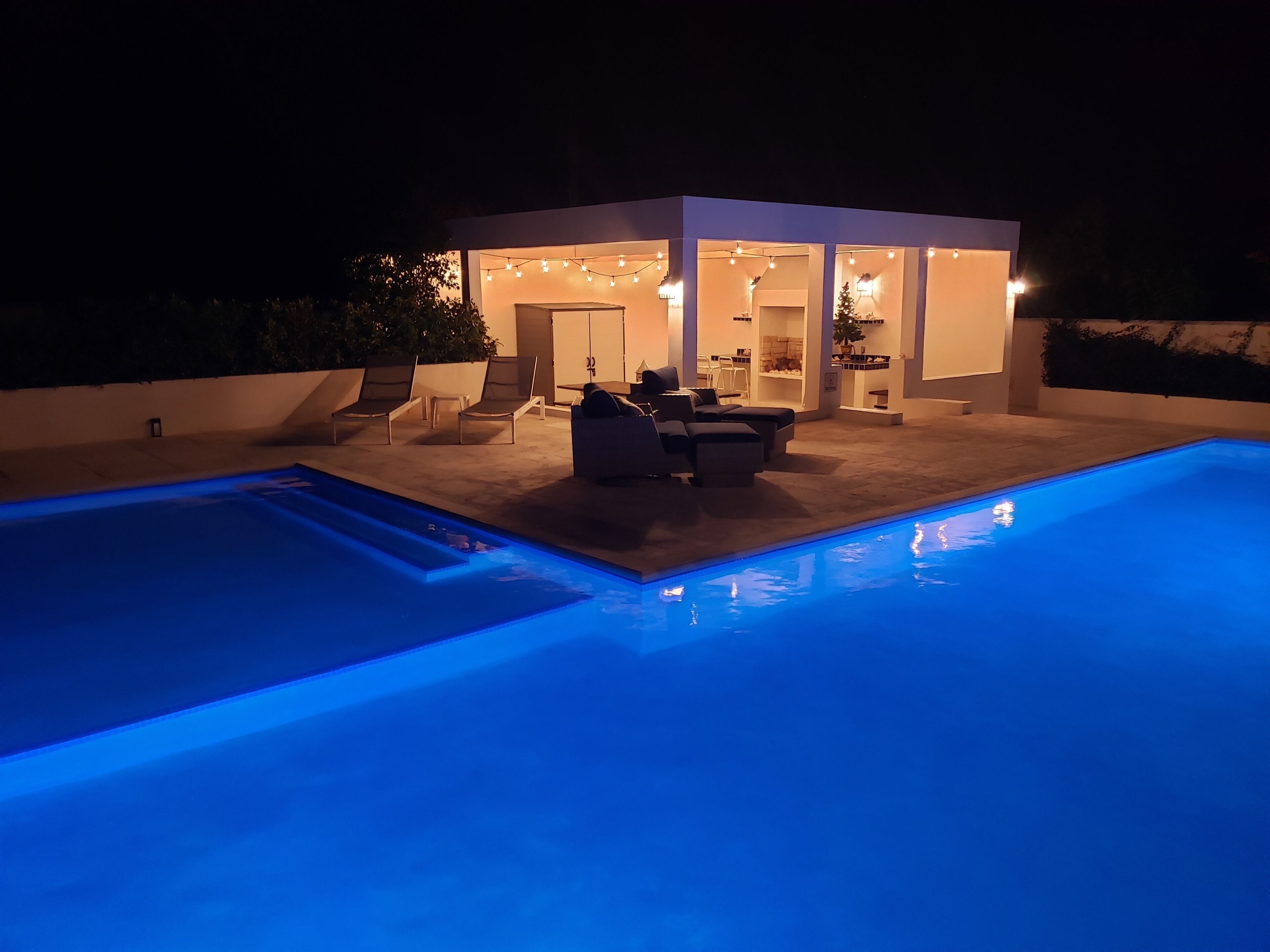 The pool and the lighted pavilion at night.